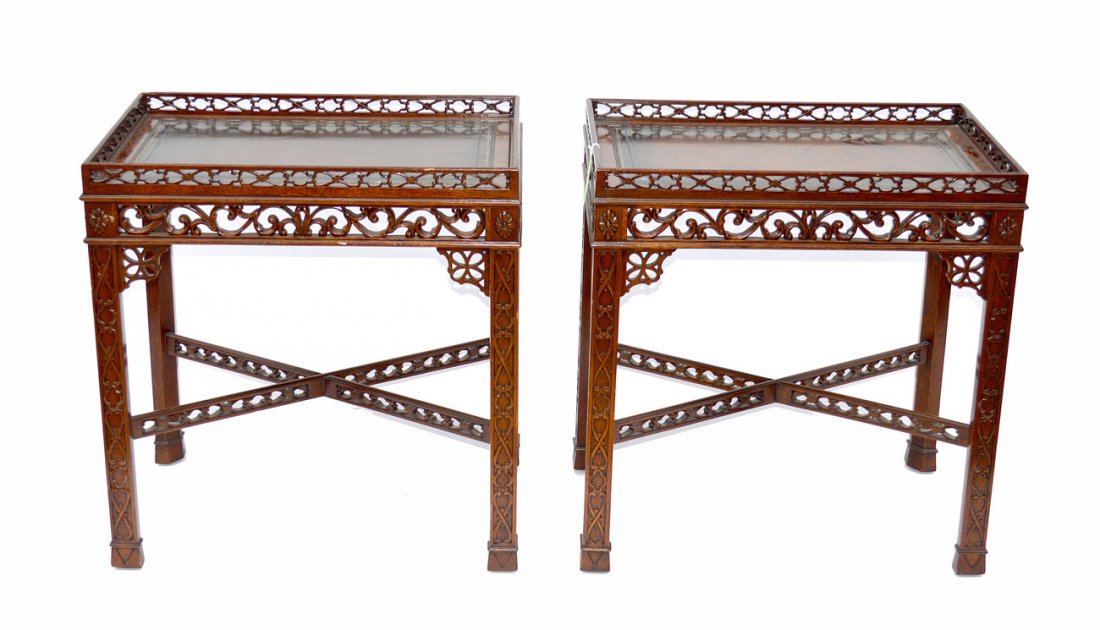 Pr. Maitland Smith Chippendale Style Side Tables: Each features carved supports with fretwork cross-stretchers and gallery tops. Both bear gilt stamped leather tips. 27 1/4" x 17 3/4"D x 28 3/4"H. In good condition.