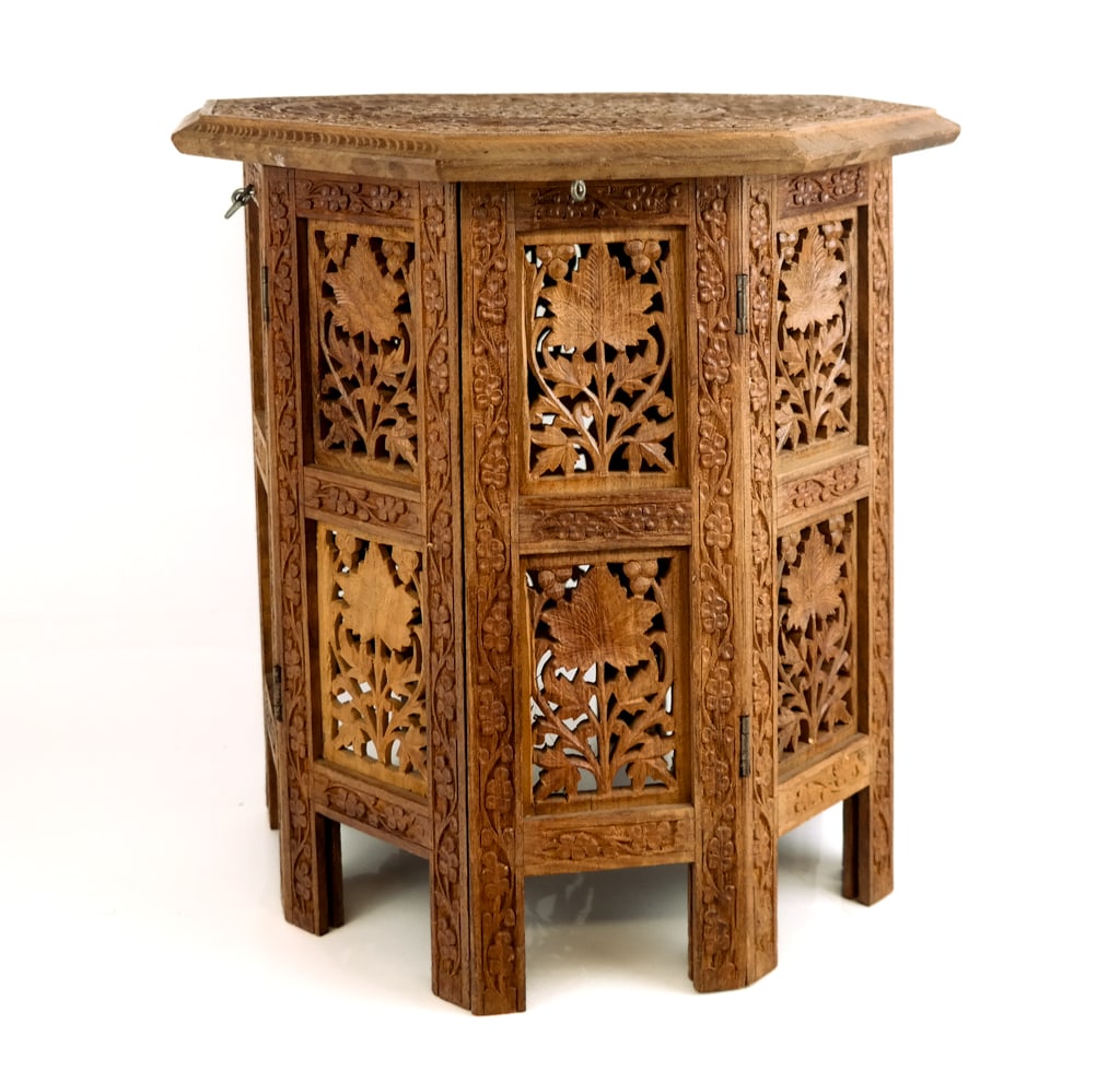 Indian Carved and Pierced Wood Modular Side Table: Indian carved and pierced wood modular side table, early 20th Century, with floral carvings throughout and pierced wood sides; the top of the table is removable with a hinged base that can be folded o