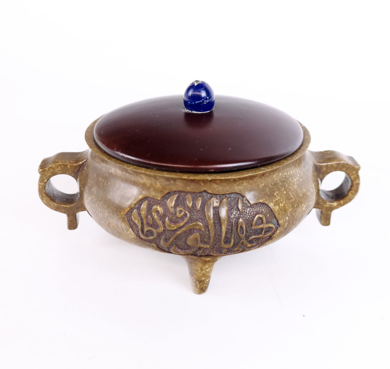 Chinese Enameled Bronze Incense Burner: A Chinese enameled bronze incense burner featuring Arabic calligraphy on front and back, featuring three feet, two handles, and a wooden top; marked "Nian Xuan Da Zhi Deming" on base. [4.25" H x 7" W