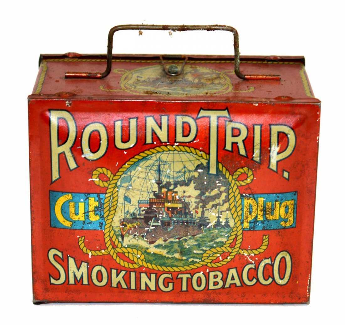 Round Trip Cut Plug Tobacco Tin: Lunch pail-type tobacco tin with latch, hinged lid, and bale handle on side. [ 6 5/8" W x 4" D x 5 1/8" H]. Scratches and scuffs with wear at edges. See photo illustrations for additional condition in