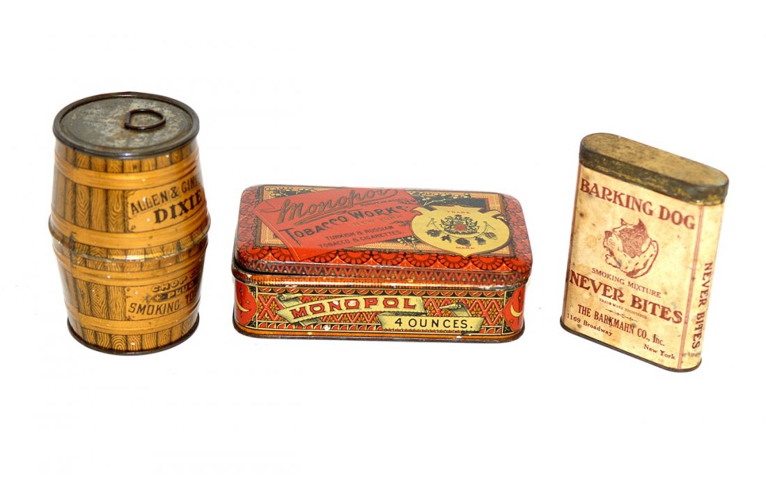 Barking Dog, Monopol, and Dixie Tobacco Tins: Comprises: 1.) Barking Dog smoking mixture pocket tin with paperwork label and hinged lid. 3 1/4" W x 1 1/8" D x 4 1/4" H. Foxing and toning to label with surface oxidation on tin, otherwise complete.