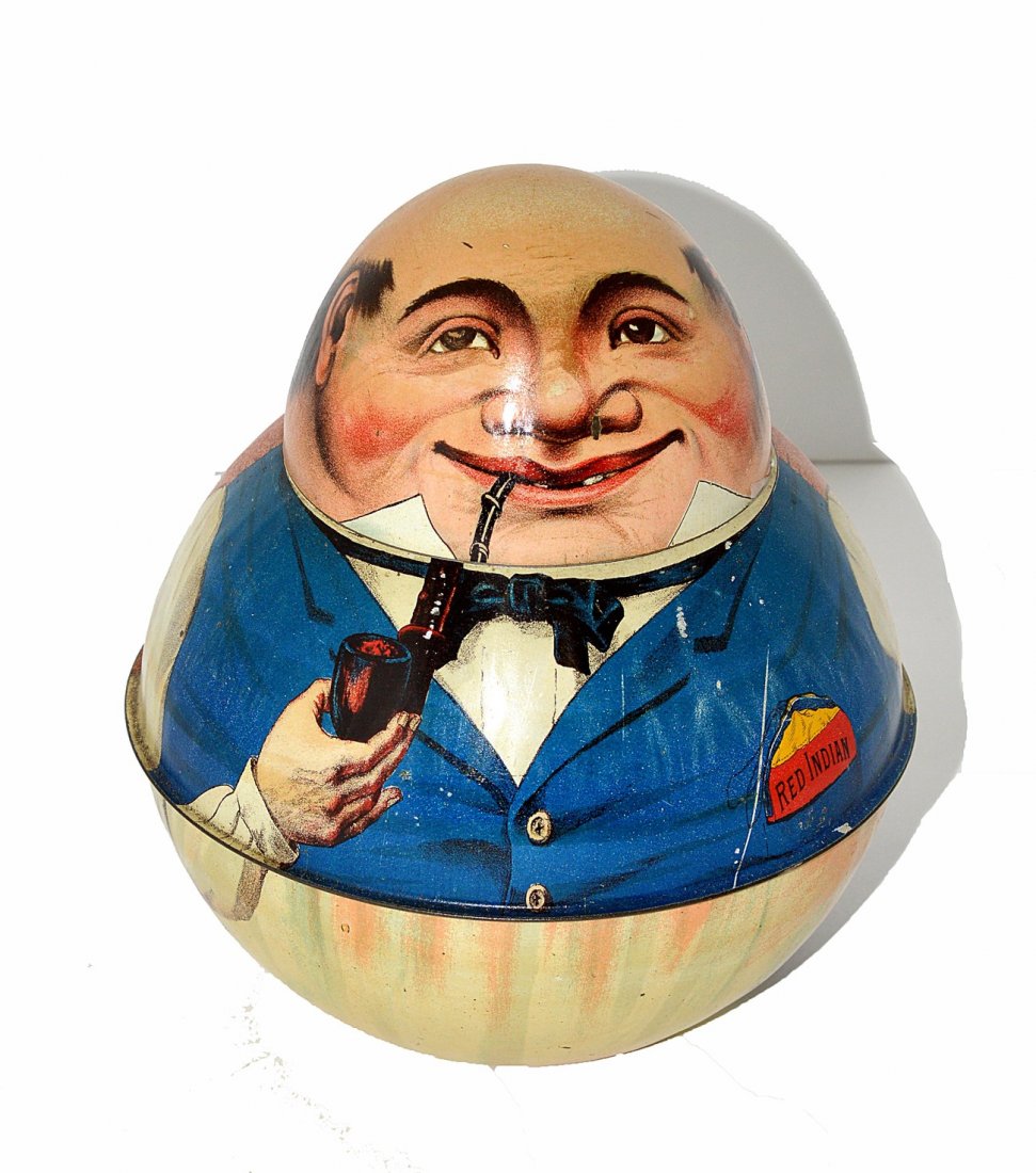 Red Indian "Store Keeper" Roly-Poly Tin: Two-piece tobacco tin. Features a smiling chap smoking a pipe and wearing a blue vest. Some scratches and scuffs [one affecting the right nostril], otherwise complete. 7" H.