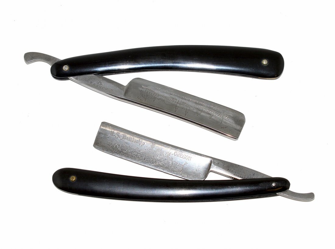 Two Straight Razors with Commemorative Blades: Both bear black ebonized scales. Blades feature: 1.) "World's Columbian Exposition, Chicago, 1893" with depiction of The Crystal Palace. Shank stamped "H. Boker & Co." 2.) "U.S. Battleship Oregon" wit