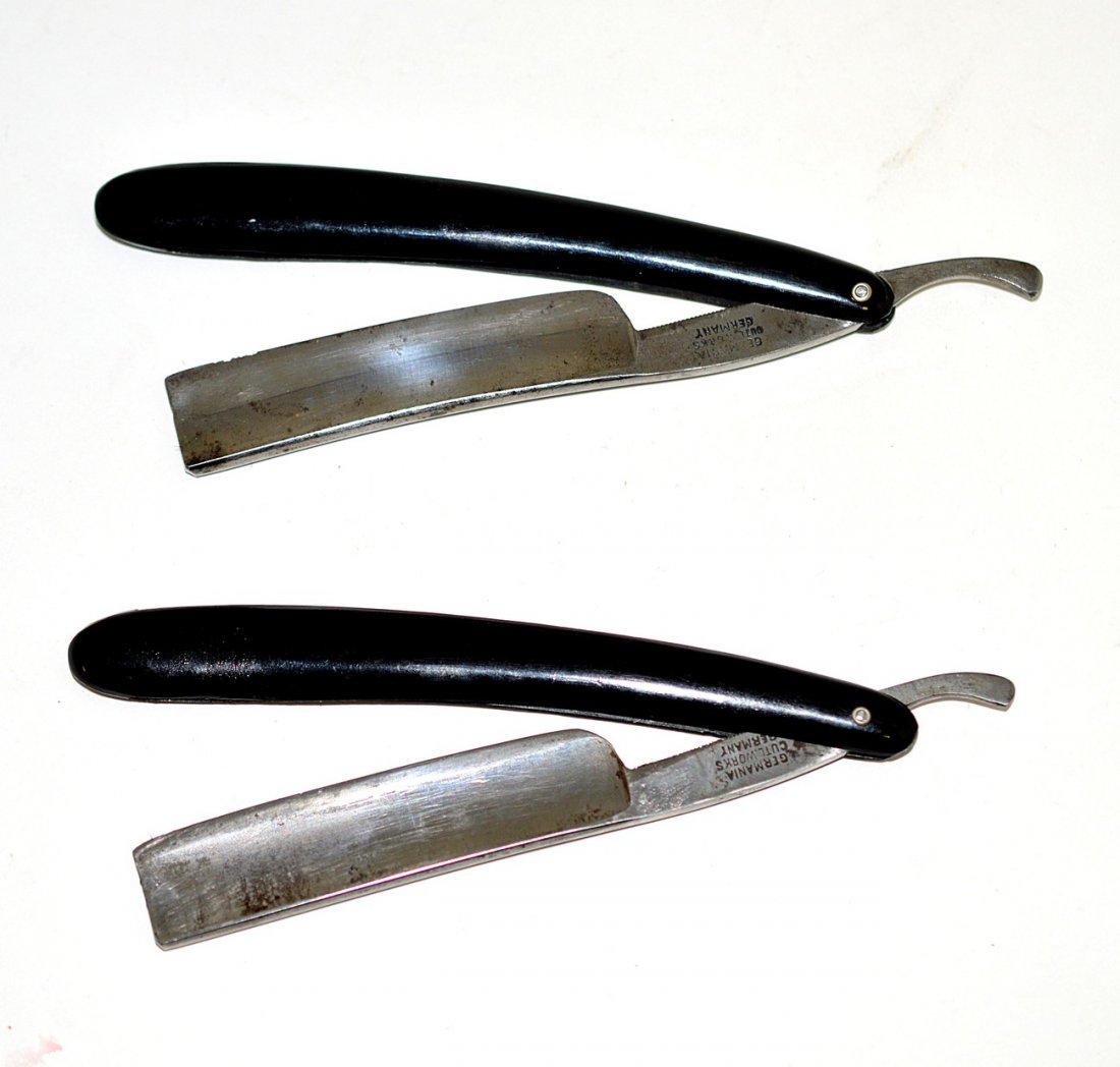 Two Straight Razors with Female Nude Scales: Identical black mould-formed celluloid scales depicting a standing female nude figure above another. Blades include: 1.) Stamped on shank "Oxford Razor...Germany" and on reverse "Germania Cutlery Work