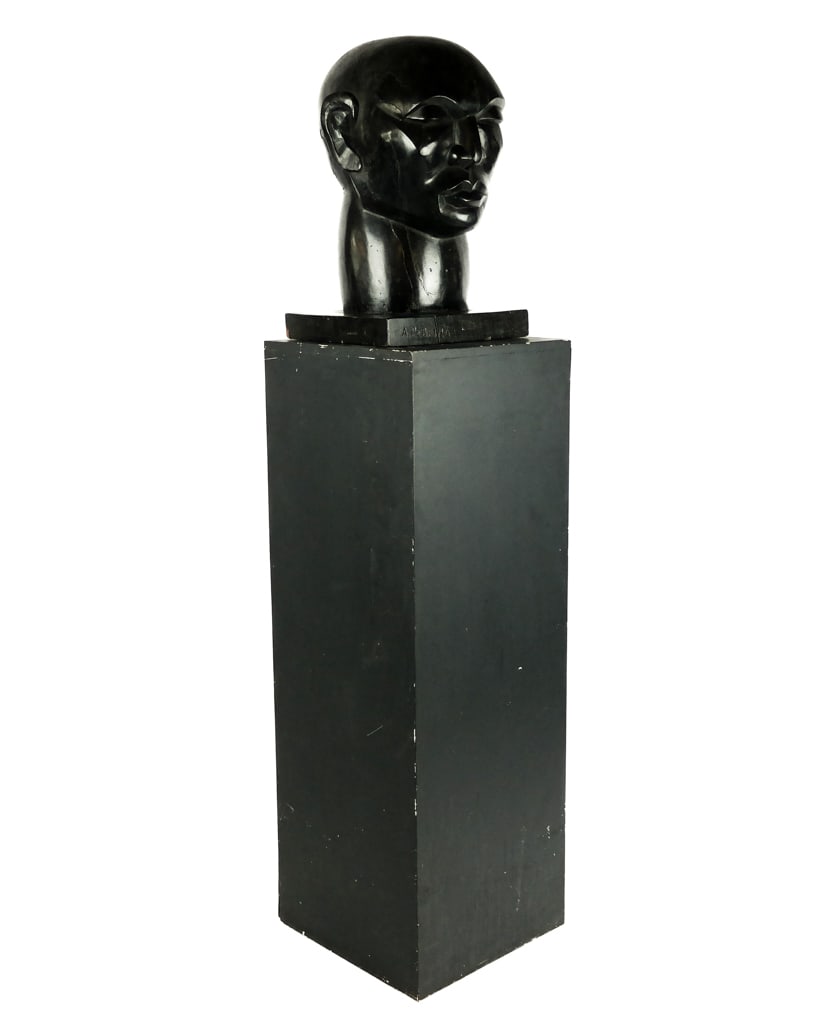 A. Pereira Carved & Ebonized Bust on Pedestal: A. Pereira carved and ebonized Cubist bust, mark to front base [Artwork: 24" H x 15.5" W x 13.5" D; bust: 58" H x 18" Square] Cracking to left side near back and crack to base, some scratches, crack t