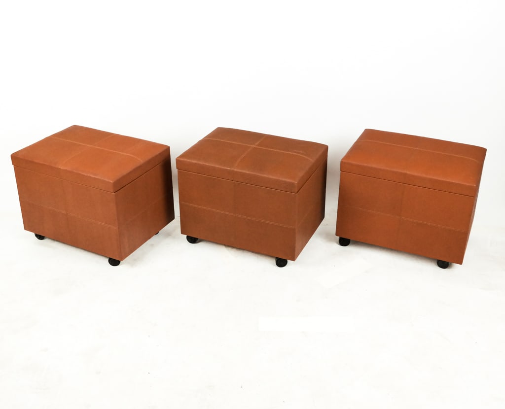 Three Mobile File Ottomans: A trio of mobile file ottomans, having a faux snakeskin exterior and faux leather interior mounted on casters. Interior contains a pouch, file racks, and a magazine rack. [17" H x 20.25" H x 14.5" D] 