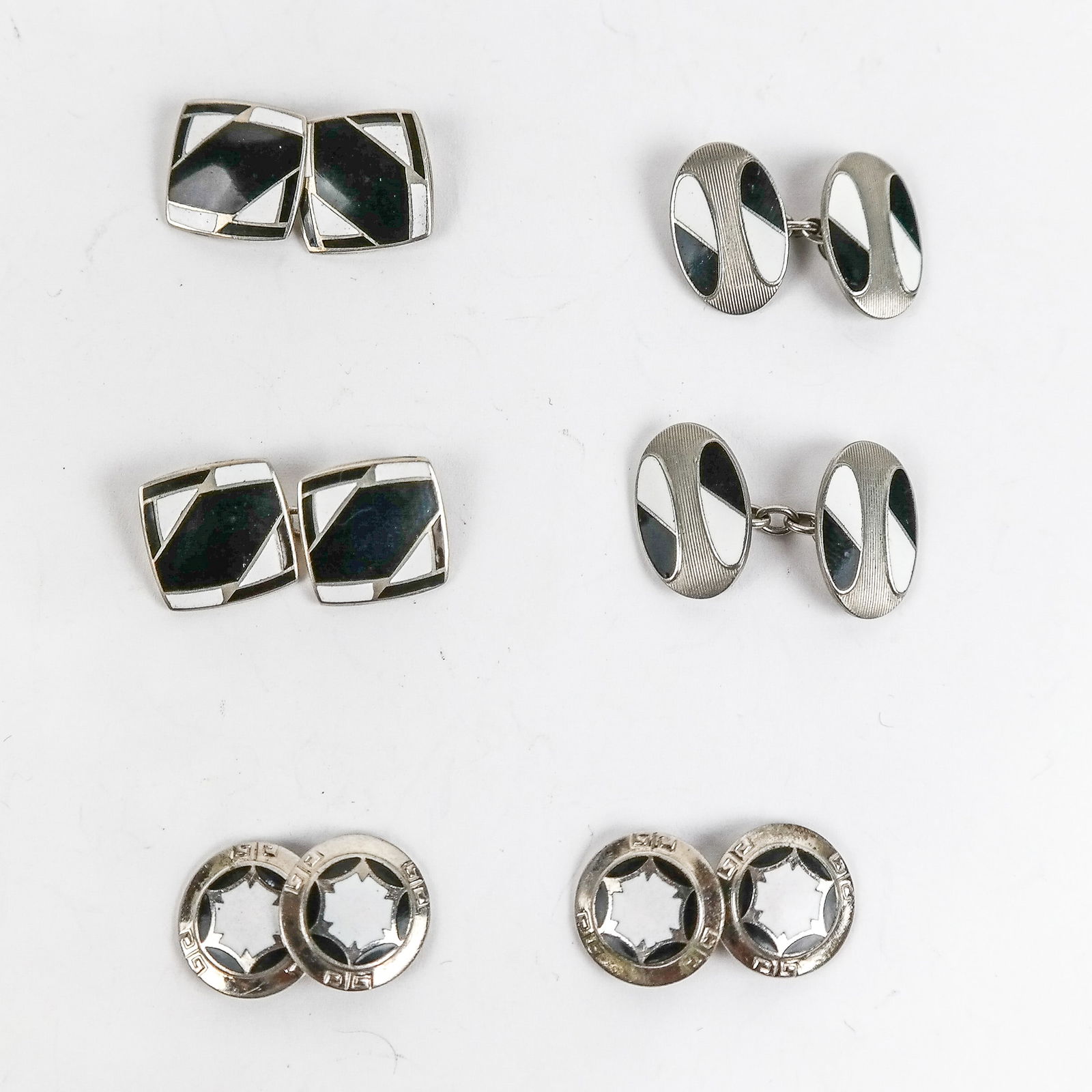 3 Pairs of Antique B&W Enamel Cufflinks: A collection of three pairs of Early-Mid 20th Century cufflinks, including: a pair of oval form deco design enamel cufflinks, bearing marks to backsides; a pair of circular silver style, black, and wh