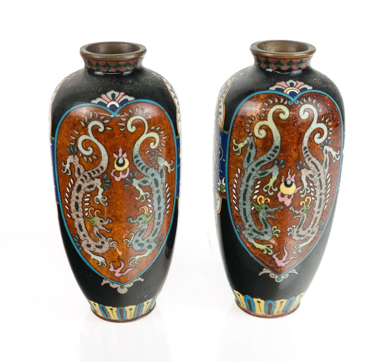 Pair of Japanese Cloisonne Vases: Pair cloisonne vases, likely Meiji Period, 20th century, with enamel decoration and a cartouche with dragons to one side and phoenixes to other, unmarked. [7" H x 3.5" Diameter]. Overall condition is 