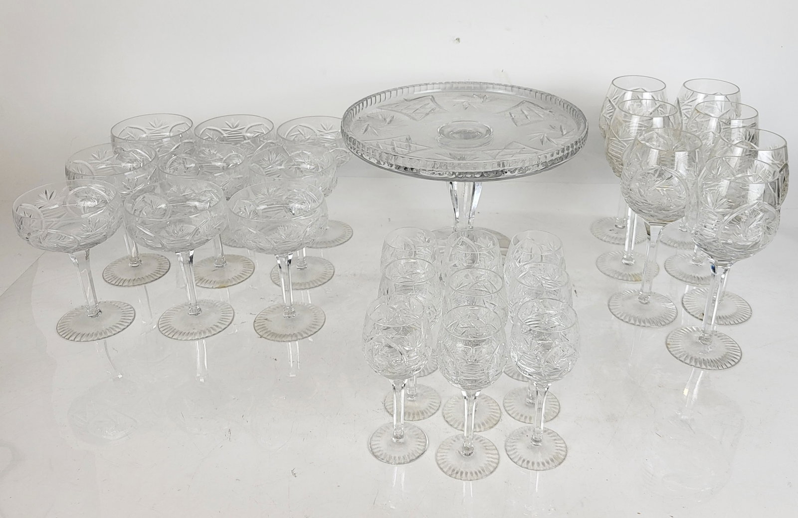 Imperial Crystal "Alexandra" Glassware: Imperial Crystal "Alexandra" Glassware and Cake Stand, comprising 8 white wine glasses [8" H], 9 champagne saucers [6" H], 9 cordials [5.75" H] and cake stand [7" H x 10.75" Diameter] Overall conditio