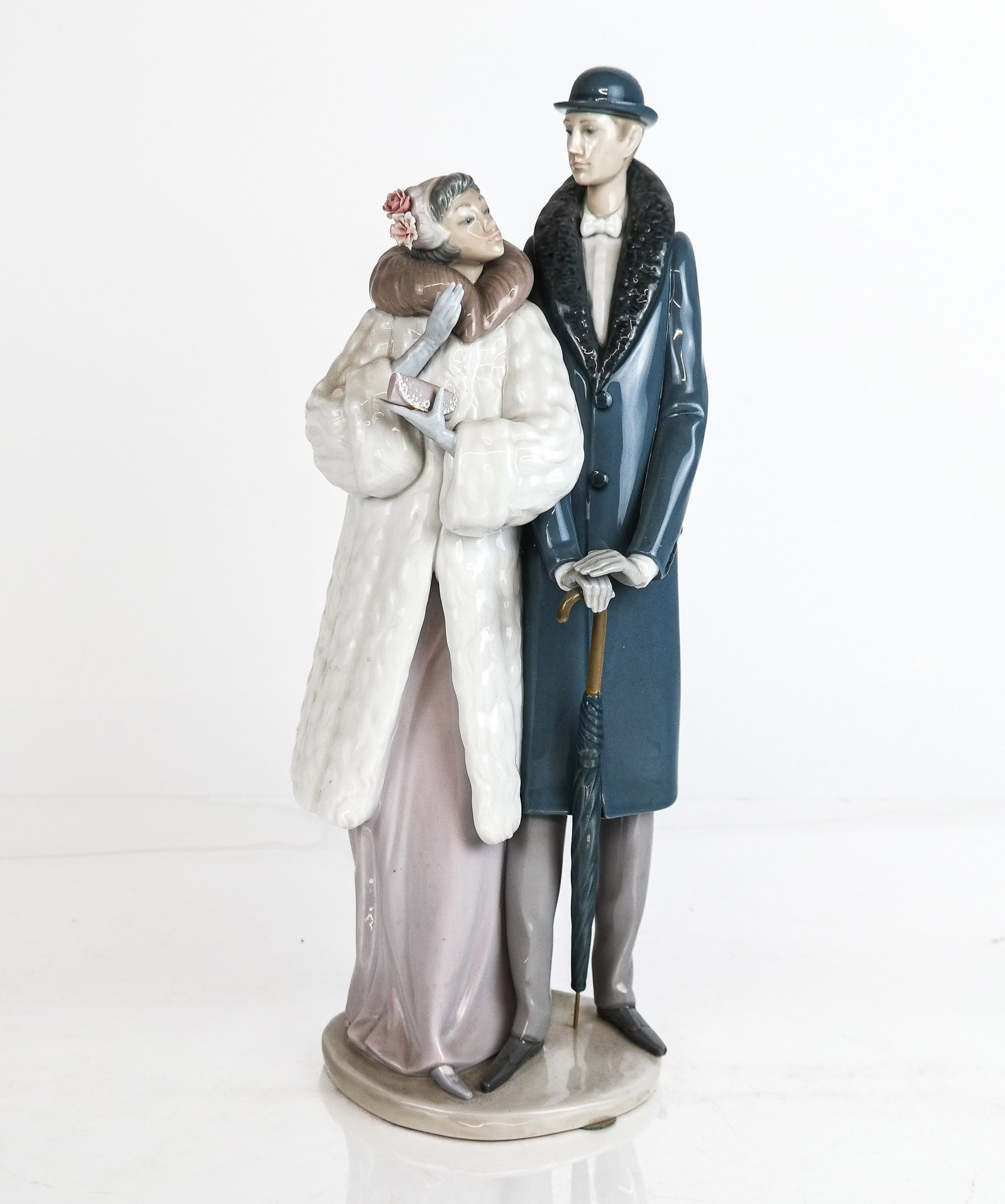 Lladro Porcelain Figure Group "On the Town": Lladro porcelain figure group "On the Town", Spanish, 20th century, mark to base [15" H x 6" W x 5.5" D] Overall condition is good.