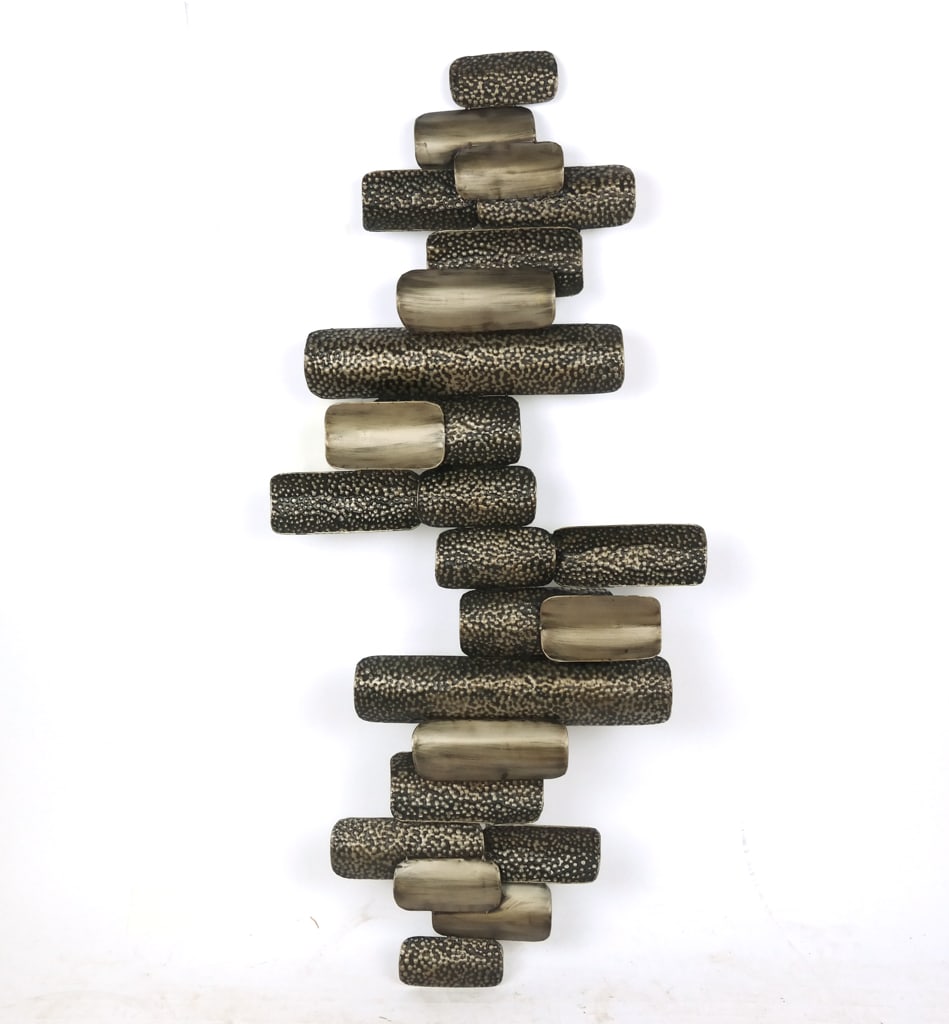 Brutalist Wall Sculpture: Brutalist patinated metal wall sculpture, 21st century, of punched and patinated metal in abstract alternating forms. [54" H x 23" W x 2" D]. Overall condition is good.