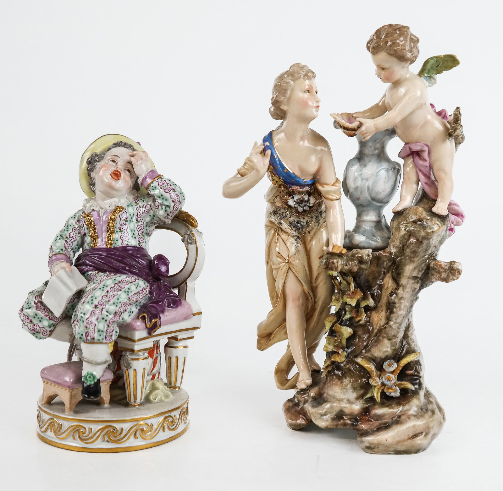 Meissen and Meissen-Inspired Porcelain Figures, 2: Meissen and Meissen-Inspired figures depicting a seated boy with book, and group depicting Psyche ad Cupid, marks to bases [Psyche and Cupid: 7.5" H x 5" W x 3" D] Overall condition is good, Psyche & 