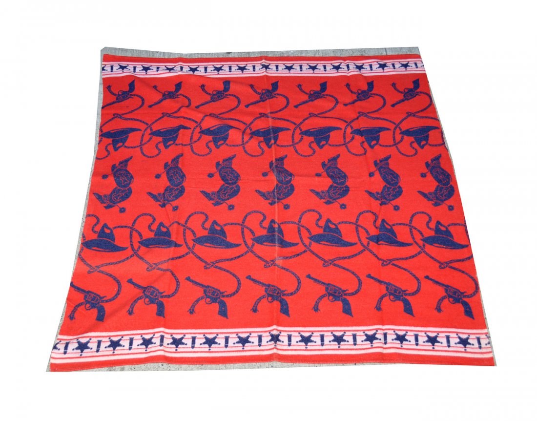 Vintage Western Theme Reversible Blanket: Wool blanket with red, white, and blue. Features: lasso, revolver, cowboy hat, bullet, and sheriff's star badge elements. 65" x 64". Minor defects, otherwise complete.