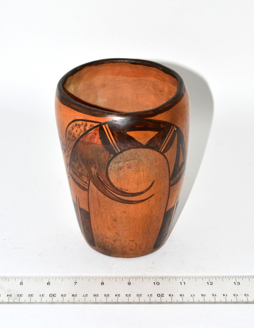 Hopi Pottery Vessel: Vase-form earthenware vessel with black and ochre abstract figural design. 6 3/4" H x 5 1/8" Dia. Some wear.