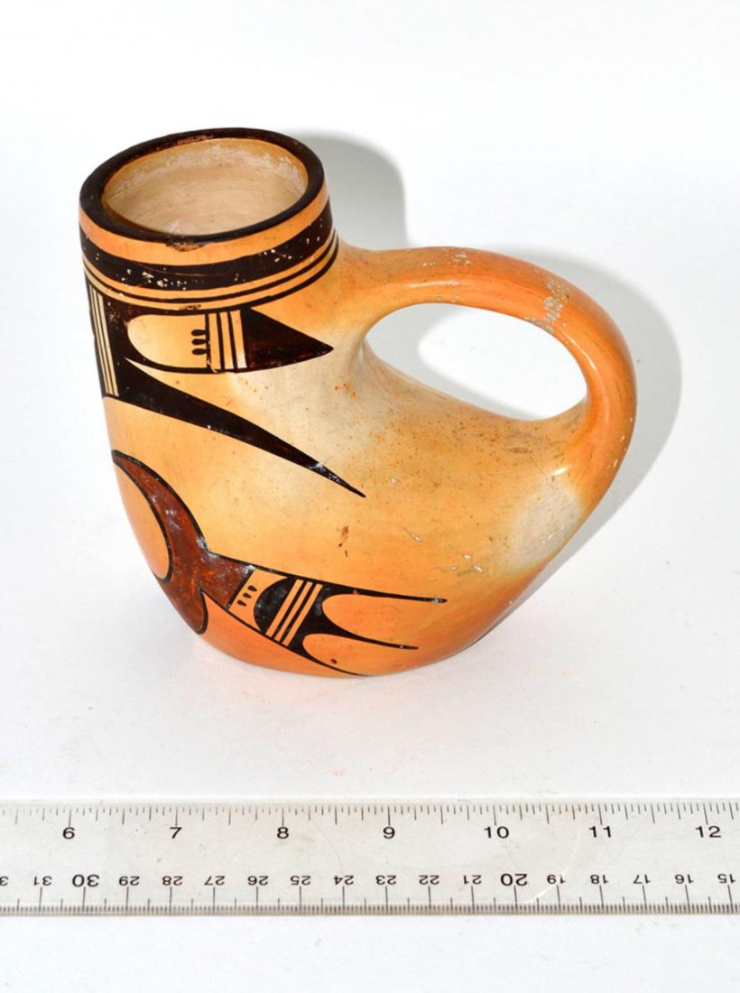Hopi Pottery Bird-Form Vessel: Ewer-form earthenware vessel with abstract bird motif in black and ochre. 5 1/4" W x 3 1/8" D x 5 1/8" H. Some wear.