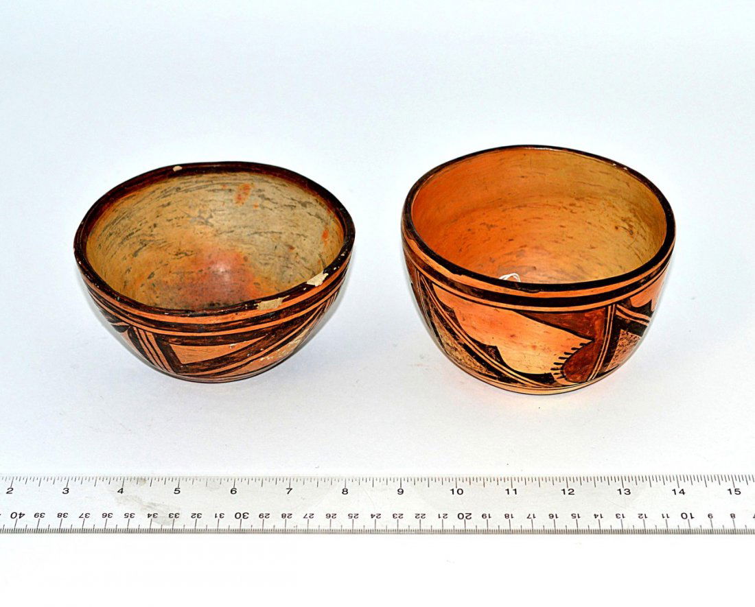 Two Hopi Pottery Bowls: Earthenware bowls. Comprises: 1.) Black geometric design. 5 3/8" Dia x 2 3/4" H. Chips on rim and wear. 2.) Black an ochre geometric design. 1/4" Dia x 3 1/8" H. Some wear.