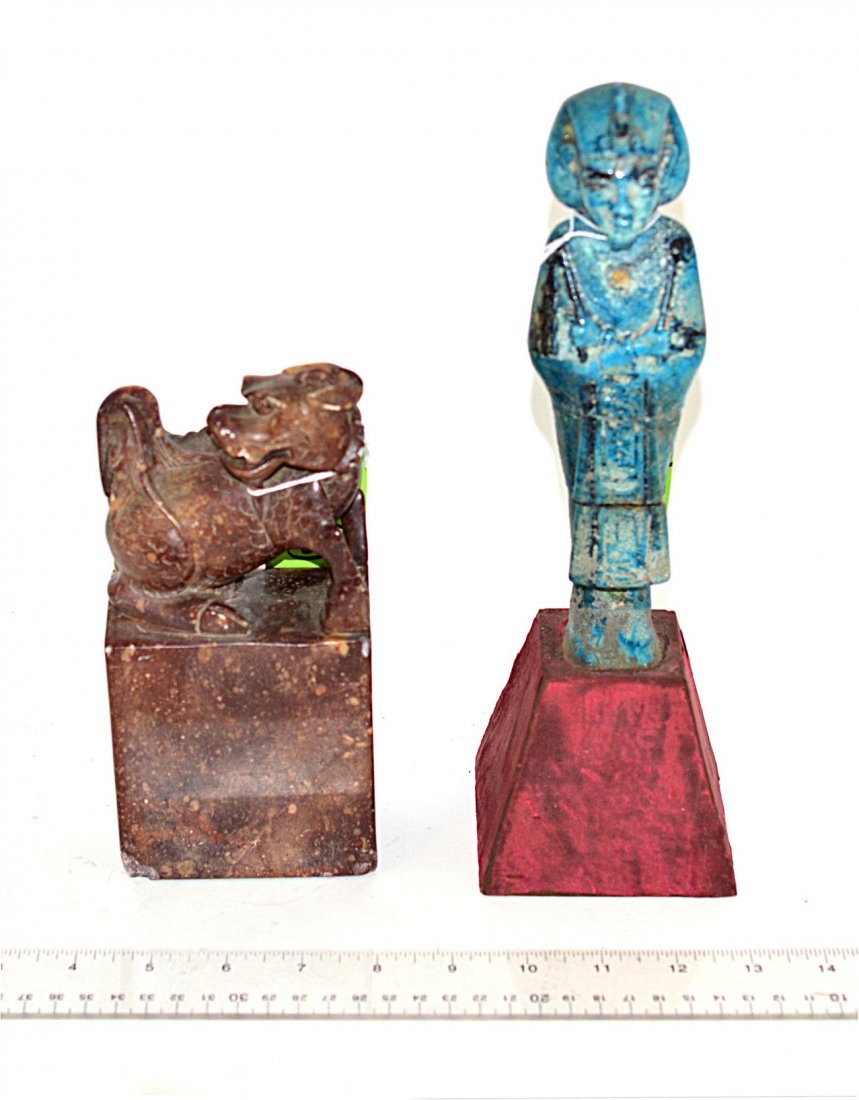 Asian & Egyptian Sculptures: Comprises: 1.) Blue glaze ceramic depiction of an ancient Egyptian ruler mounted on a tapering plinth base. Overall: 11 1/4" H [figure only 8" H]. Multiple repairs,a is. 2.) Carved hardstone foo dog o