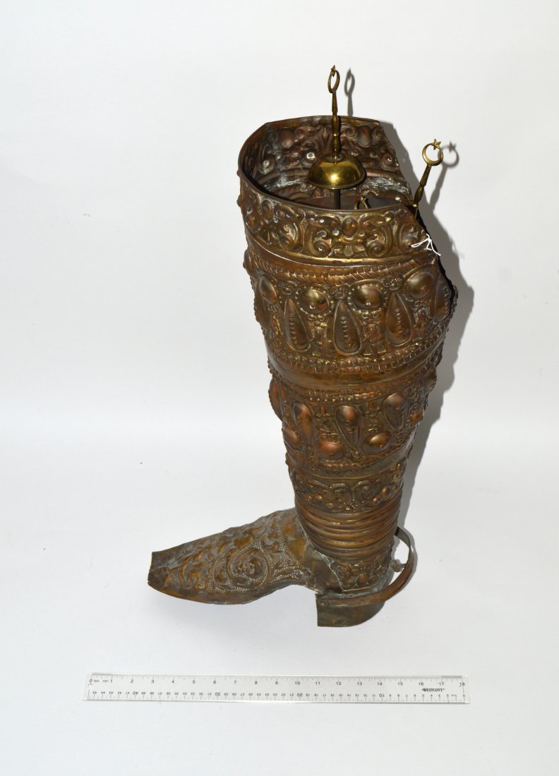 Ornate Spanish Copper Boot Form Scuttle: Al over repousse copper scuttle (7 1/4"W x 13"D x 26"H). Accompanied by 12 steel blade, brass handle, shish kebab skewers. Stamped "Istanbul." Each 19 1/2" long.