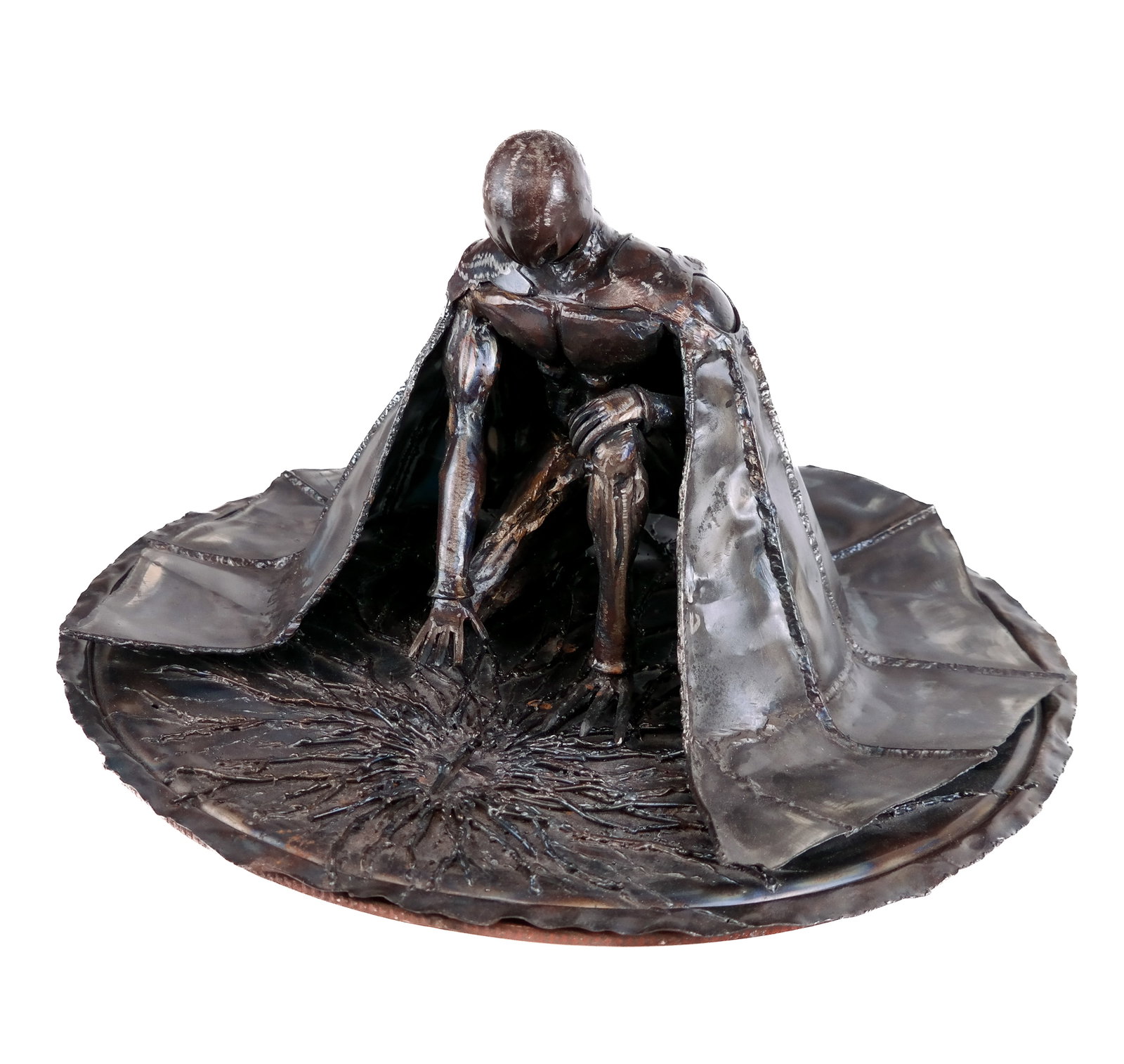 Metal Sculpture of a Draped Figure: Metal sculpture of a draped figure wearing a mask on their knee with a cape falling around them. [13" H x 24.5" W] Overall condition is good. From the esteemed collection of Neil Zukerman former owner