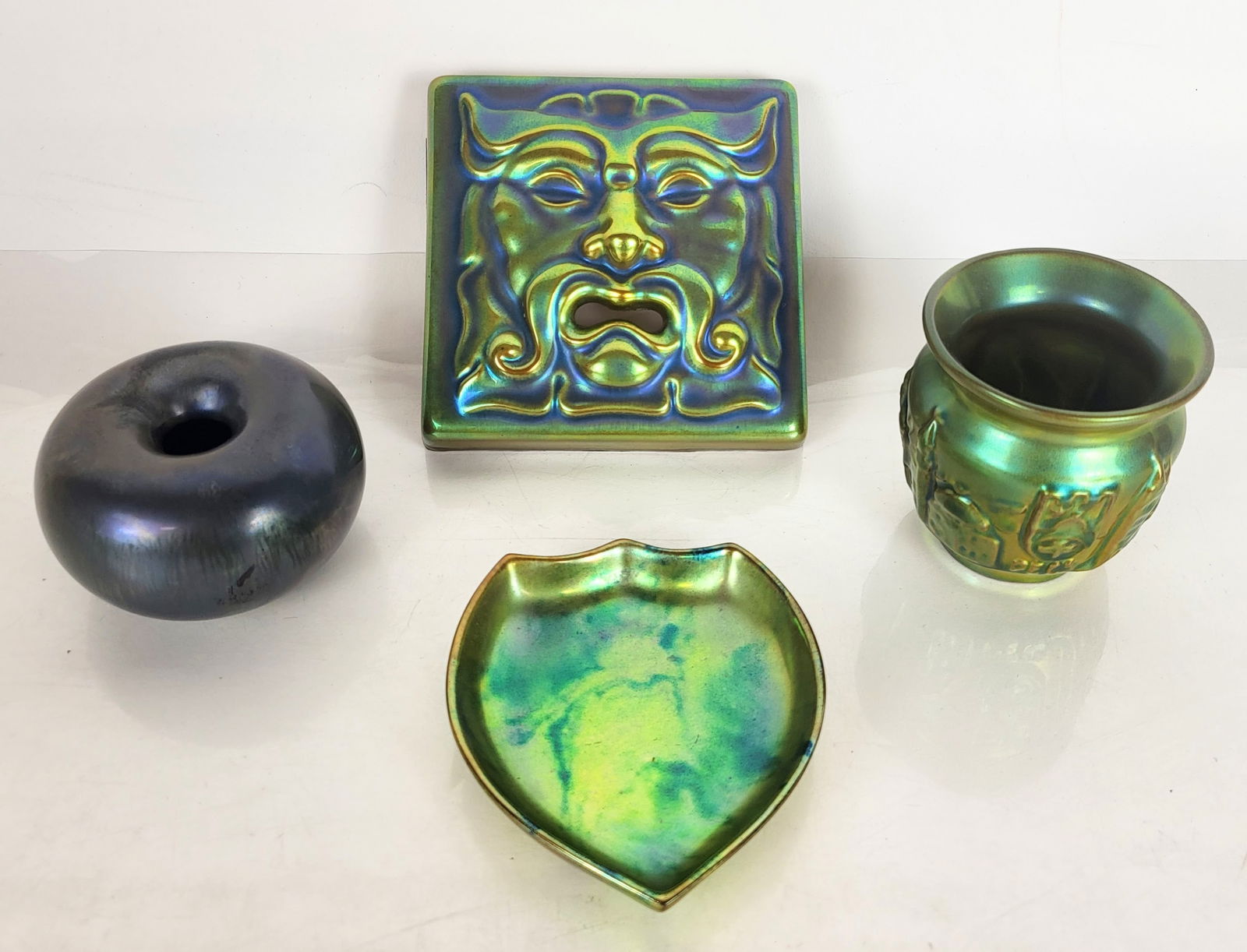 Zsolnay Collection of Eosin-Glazed Ornaments, 4: Zsolnay collection of 4 assorted table accessories, Pecs Hungary, mostly first half of the 19th century, comprising shield-shaped dish in iridescent yellows and blues, landscape vase in soft iridescen