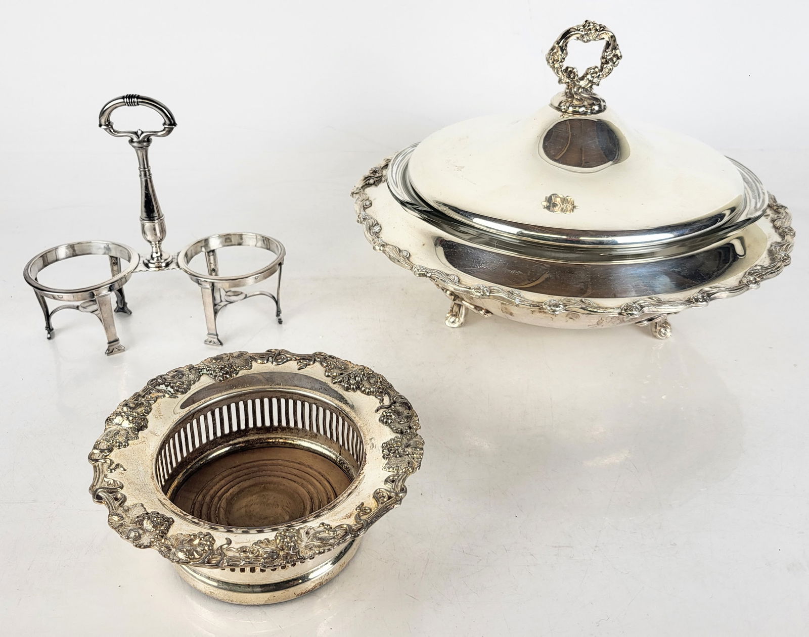 Silver Plate Wine Coaster & Covered Vegetable Dish: Two silver plate table wares comprising grape leaf bordered wine coaster with wood base, and covered vegetable dish [Wine coaster: 2.5 H x 6" Diameter; Covered Vegetable Dish: 9" H x 12" Diameter] Ove