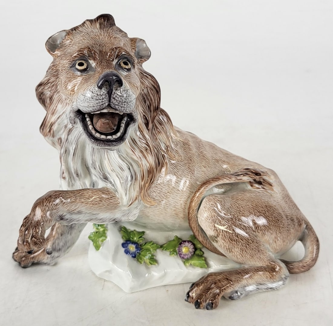 Meissen Porcelain Figure of a Lion: Meissen polycrhome decorated figure of a lion, German, 1815 - 1923,, on a foliate decorated base, marked Meissen to base. [6" H x 6.5" W x 4" D]. Overall condition is good. From the esteemed collectio