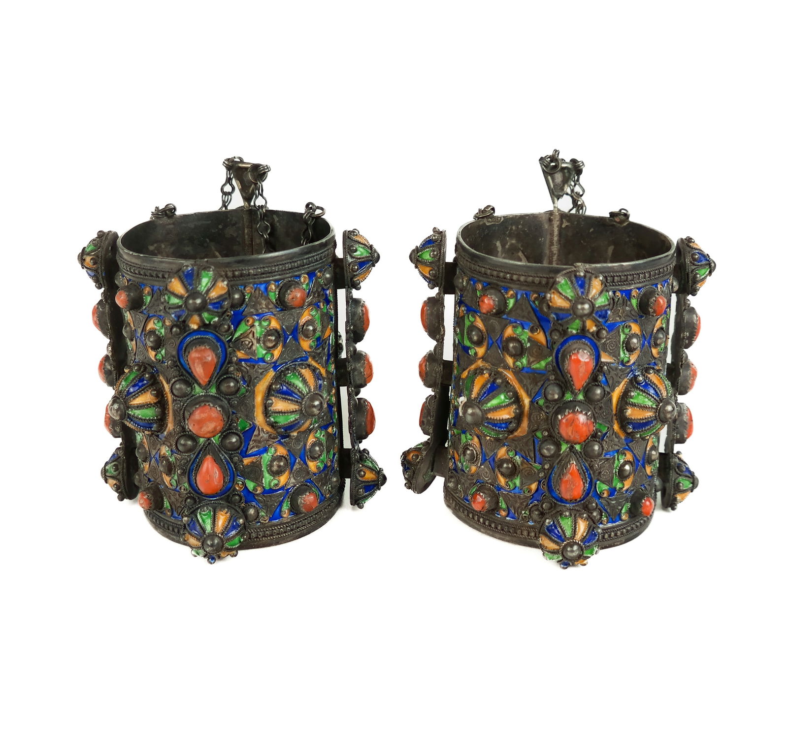 Pair of Silver, Enamel and Coral Bracelets: Pair of Kabylie-inspired silver, enamel and coral cuff bracelets, possibly Algerian, marks to interior. [total 27 ozt. inclusive, 4.75" H inclusive of clasp pin x 2.75" Interior diameter] Overall cond