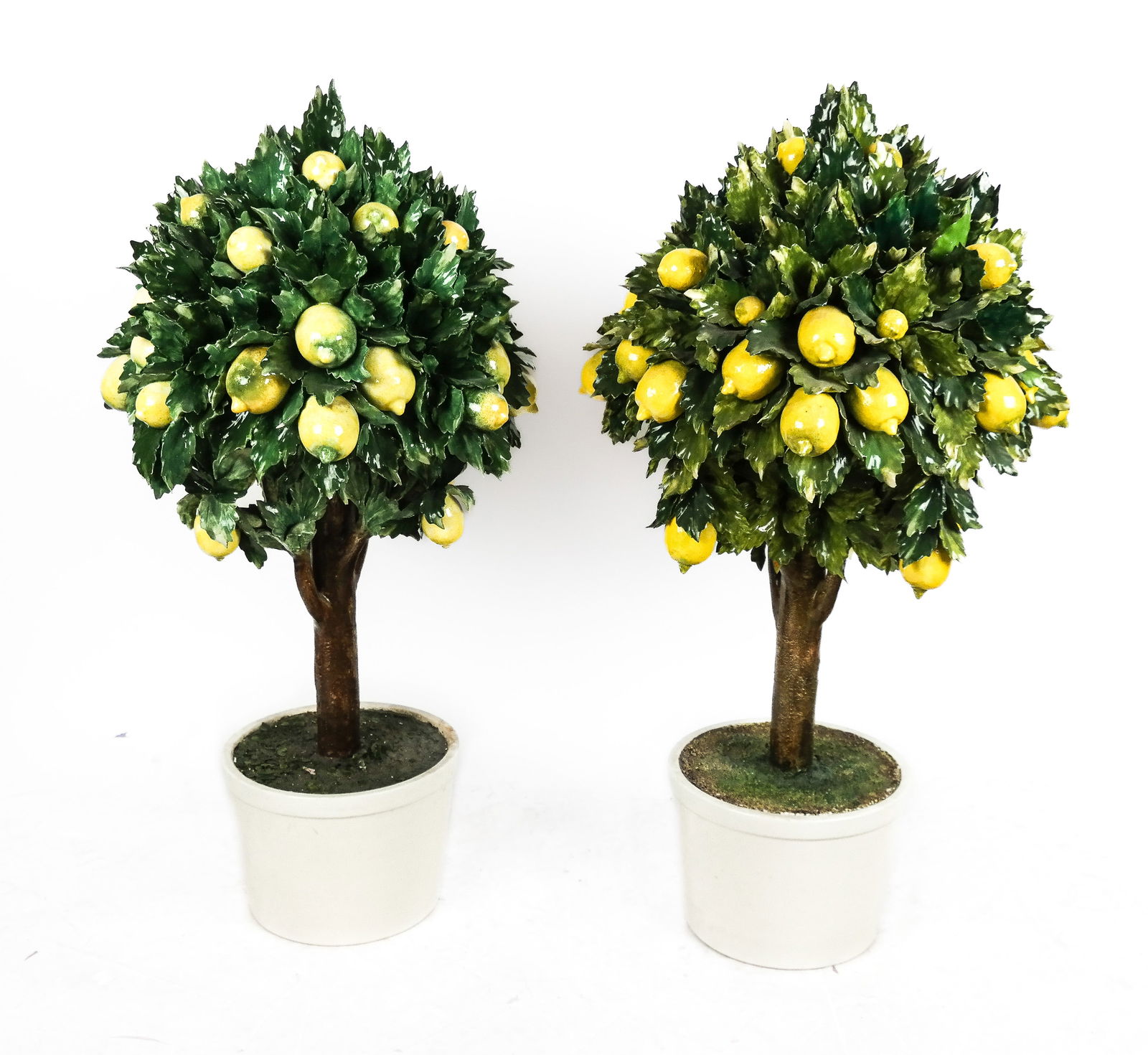 Capodimonte Pair of Lemon Topiaries: Pair of Capodimonte lemon topiaries, late 20th century, marked L'Atelier Ceramiche D'Arte Capodimonte, and Made in Italy to bases. [41" H x 24" Diameter]. Overall condition is good with scattered mino