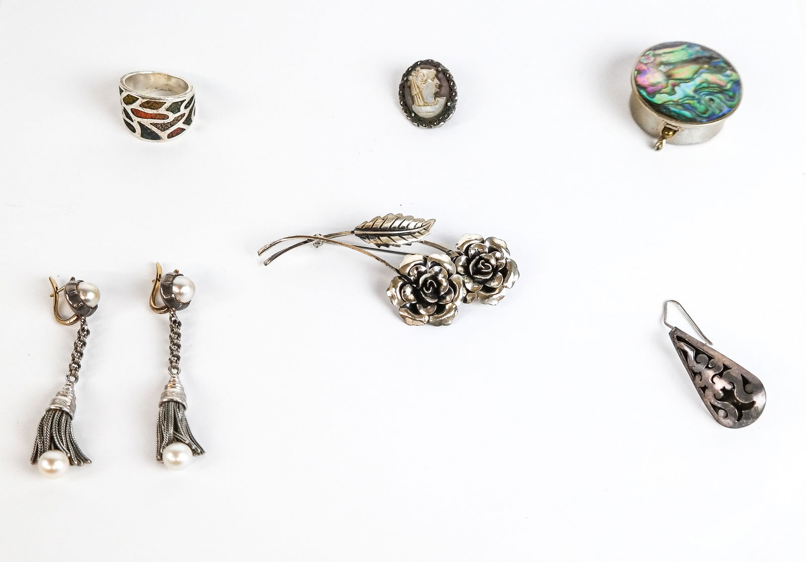 Group of Silver & Metal Jewelry and Accessories, 7: Group of silver and metal items comprising 2 single earrings, pair of earrings, brooch, ring and pill box. Overall condition is good. Property from the Estate of Pearl Strull.