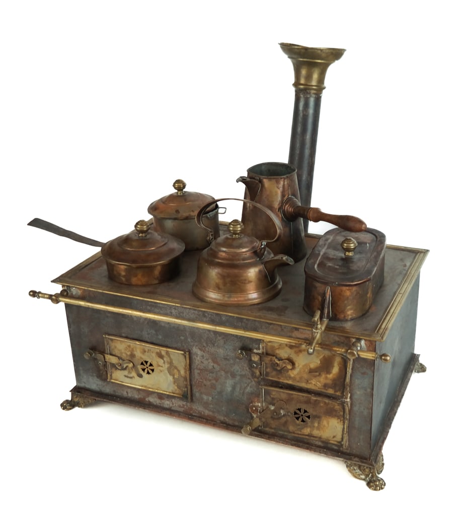 Marklin Diminutive Child's Cookstove: Marklin (German) diminutive child's toy tin plate, brass, and copper cook stove, circa early 20th century, with a brass mounted chimney over five burners with a copper coffee or hot chocolate pot, two