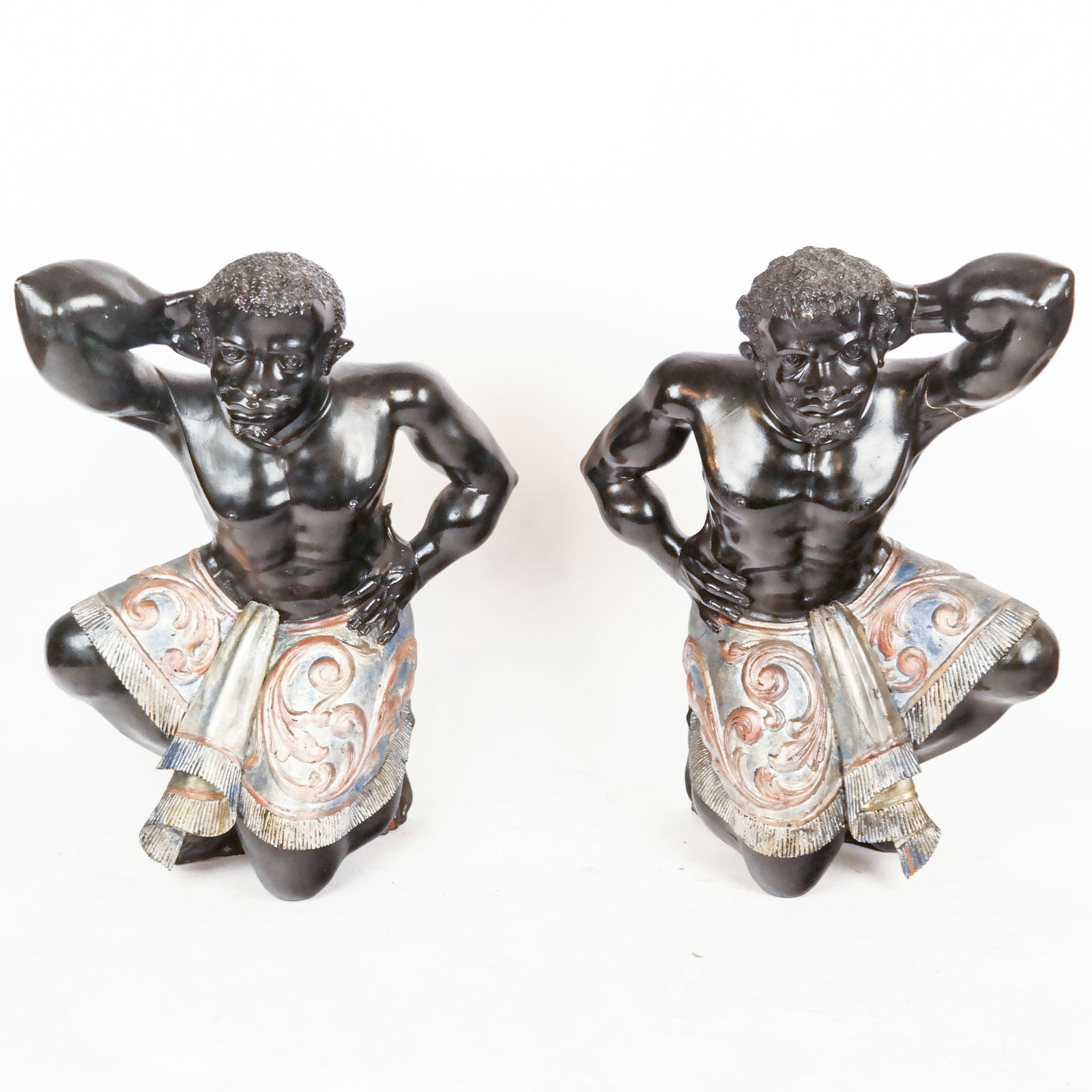 Venetian-Style Rococo Blackamoor Figure: Italian Venetian style 18th-19th century wood carved life-size blackamoor kneeling figure wearing apolychrome decorated skirt. With cracks, restorations, loses, and possibly areas of wear.