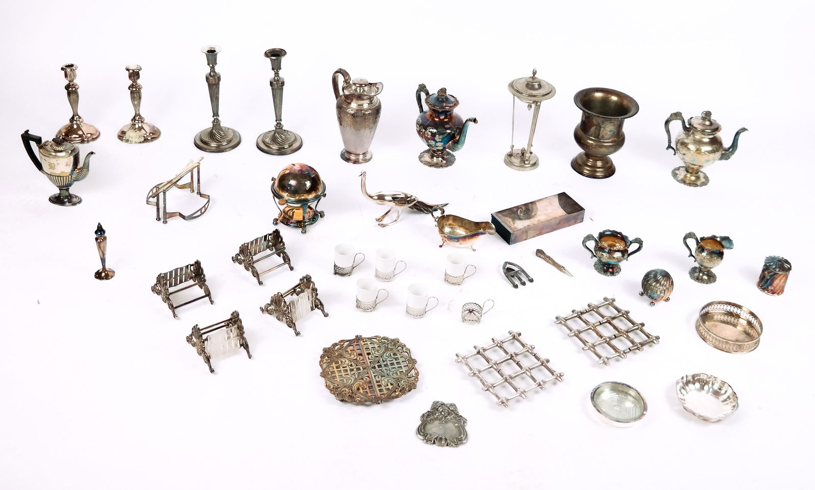 Assorted Silverplate Wares, 20+: Set of 20+ pieces of silverplate, including: candlesticks, creamers, teapots, trinket dishes, sugar bowls, tea cup holders, trivets, an urn form wine cooler, etc. [Urn form wine cooler: 8.75" H x 7.5"