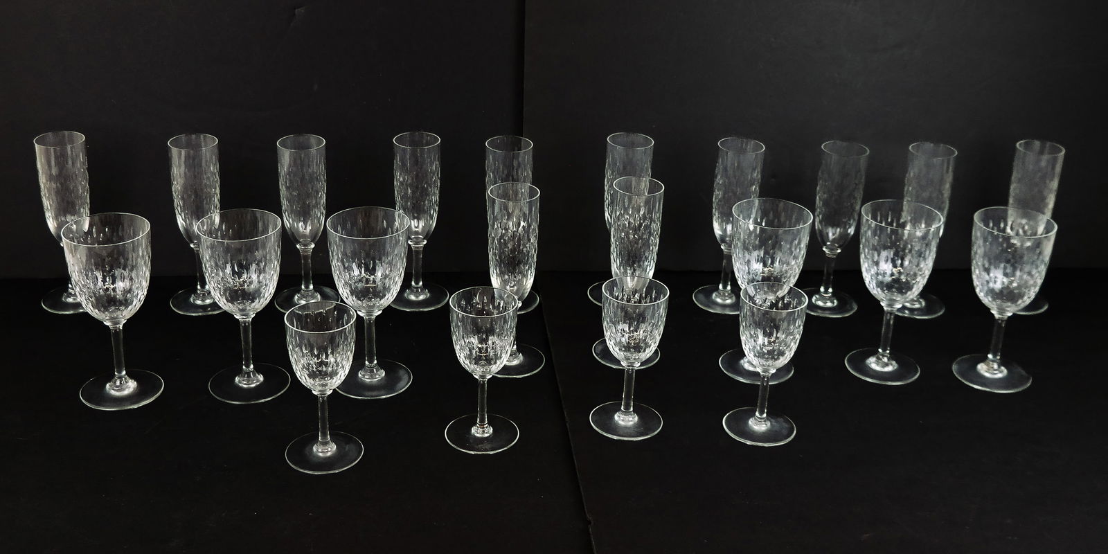Baccarat "Paris" Stemware, 22: 22 pieces of Baccarat "Paris" stemware, late 20th century, with grain de riz pattern, comprising 12 champagne flutes, six wine goblets, and four cordials. [Wine goblets: 6.5" H x 3" Diameter]. Overall
