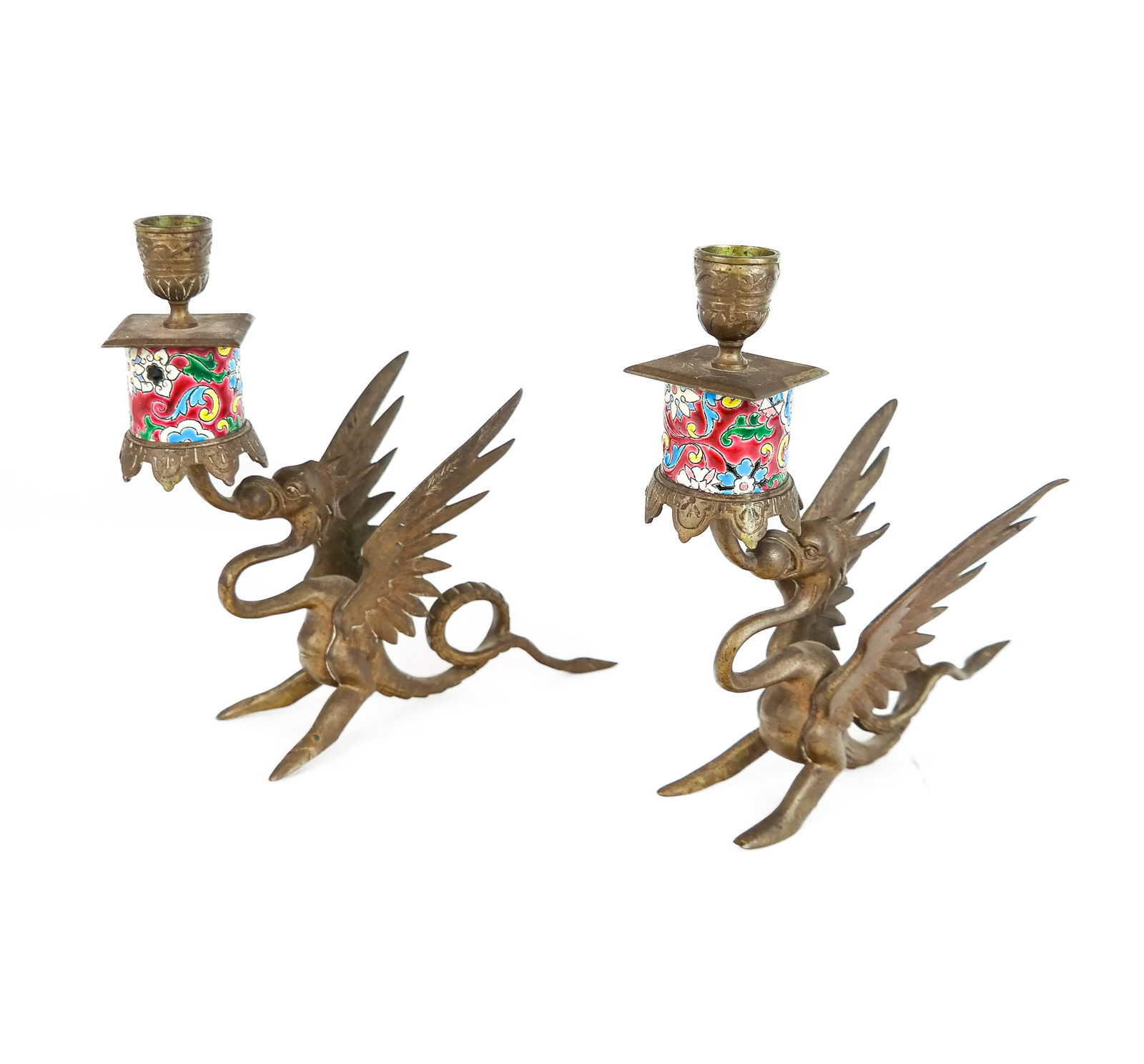 Chinese Brass Griffin-Form Candlesticks: Chinese brass griffin-form candlestick holders, 19/20th century, with a porcelain polychrome accent. [9.5" H x 3.5" W x 8.5" D]. Overall condition is good with patina to brass.
