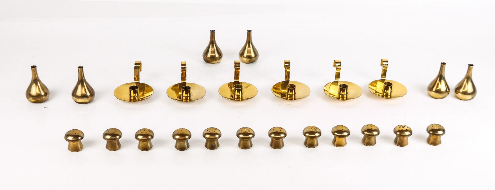 Mid-Century Modern Brass Table Accessories, 24: 24 Mid-Century Modern brass table accessories, circa mid-20th century, comprising six pairs of St. Medard salt and pepper shakers, marked Made on France and marked St. Medard, six Dansk bud vase form