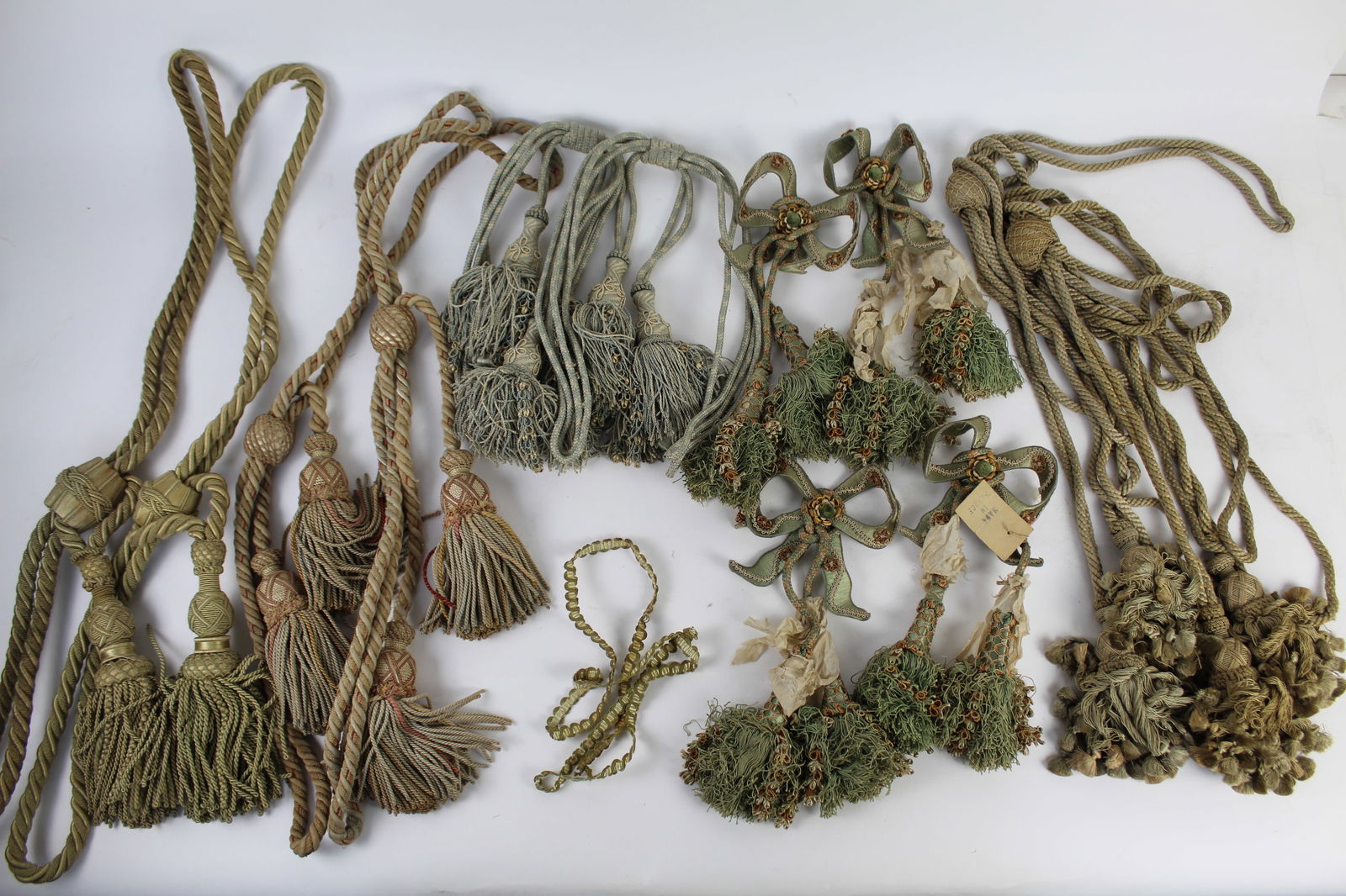 Collection of Antique Upholstery Silk Tassels: Collection of upholstery tassels, comprising one pair of green silk curtain ties with tassels and braided cords; one pair of pink silk and ecru curtain ties with tassels and braided cords; one pair of