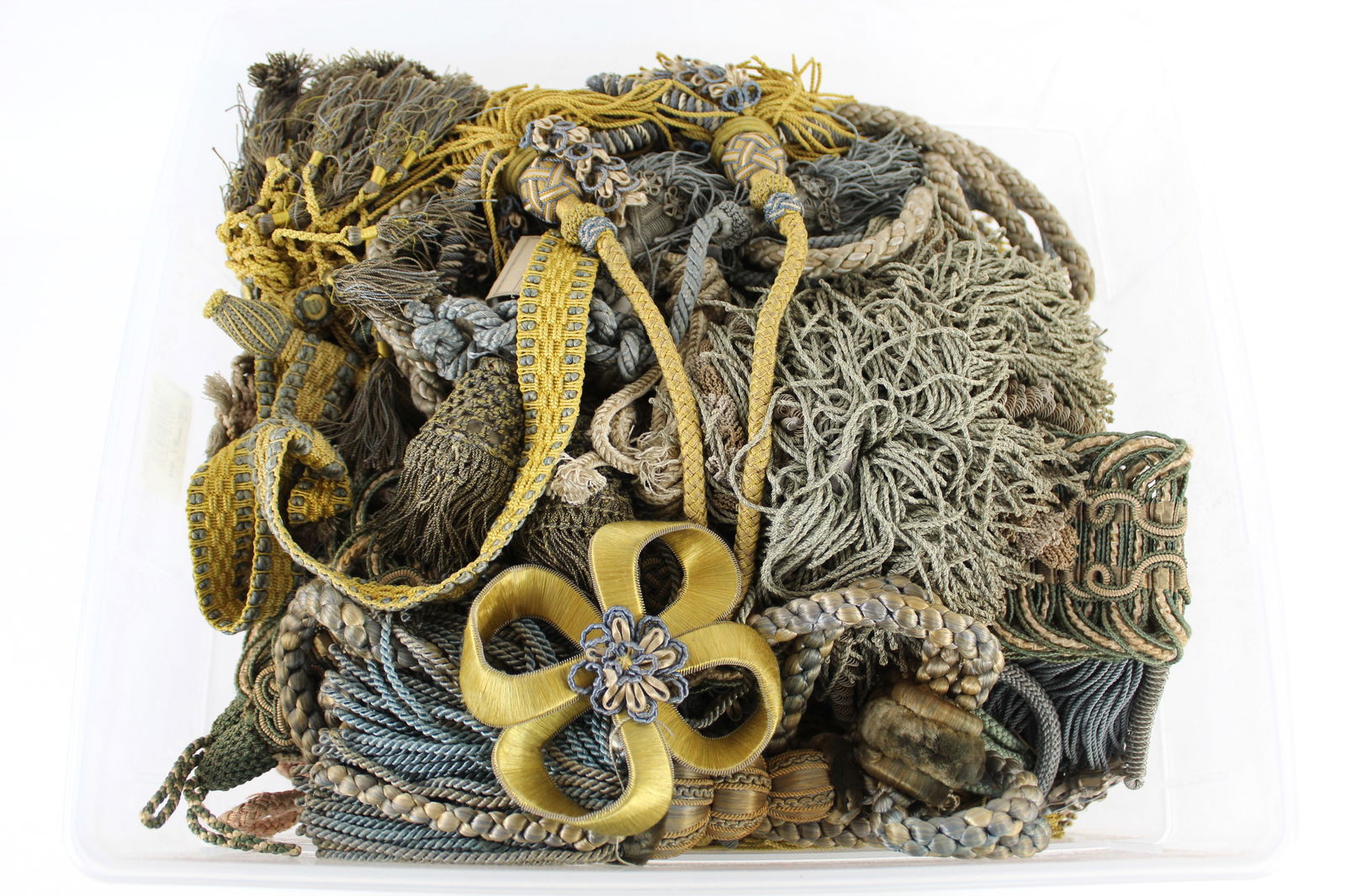 Collection of Antique Upholstery Silk Tassels: Large collection of antique silk tassels, including multiple pairs of large tassels with matching silk cords in pink, green, yellow, blue, and pale gold. Some with elaborate knotting in the tassels. P
