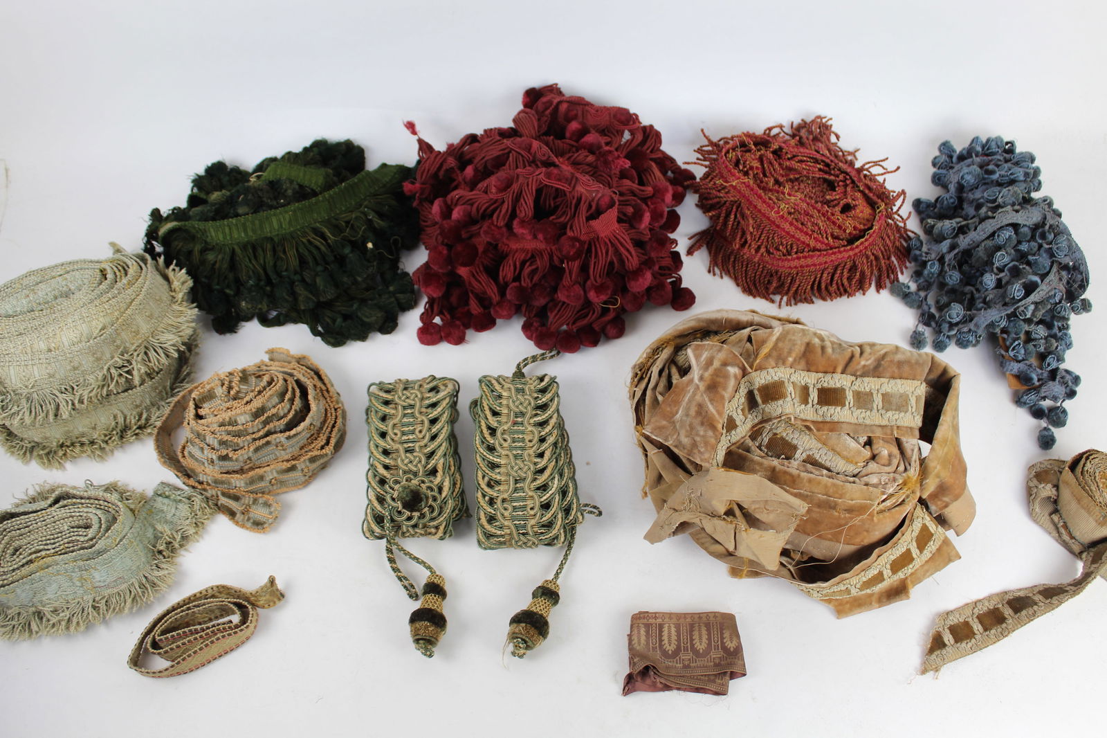 Assorted Antique Upholstery Trimmings, Etc.: Assorted silk, cotton, and metallic upholstery trimmings, in ten patterns, including red silk deep fringe trim, at least 5 yds; green silk deep fringe trim, at least 5 yds; blue silk fringe and pom po