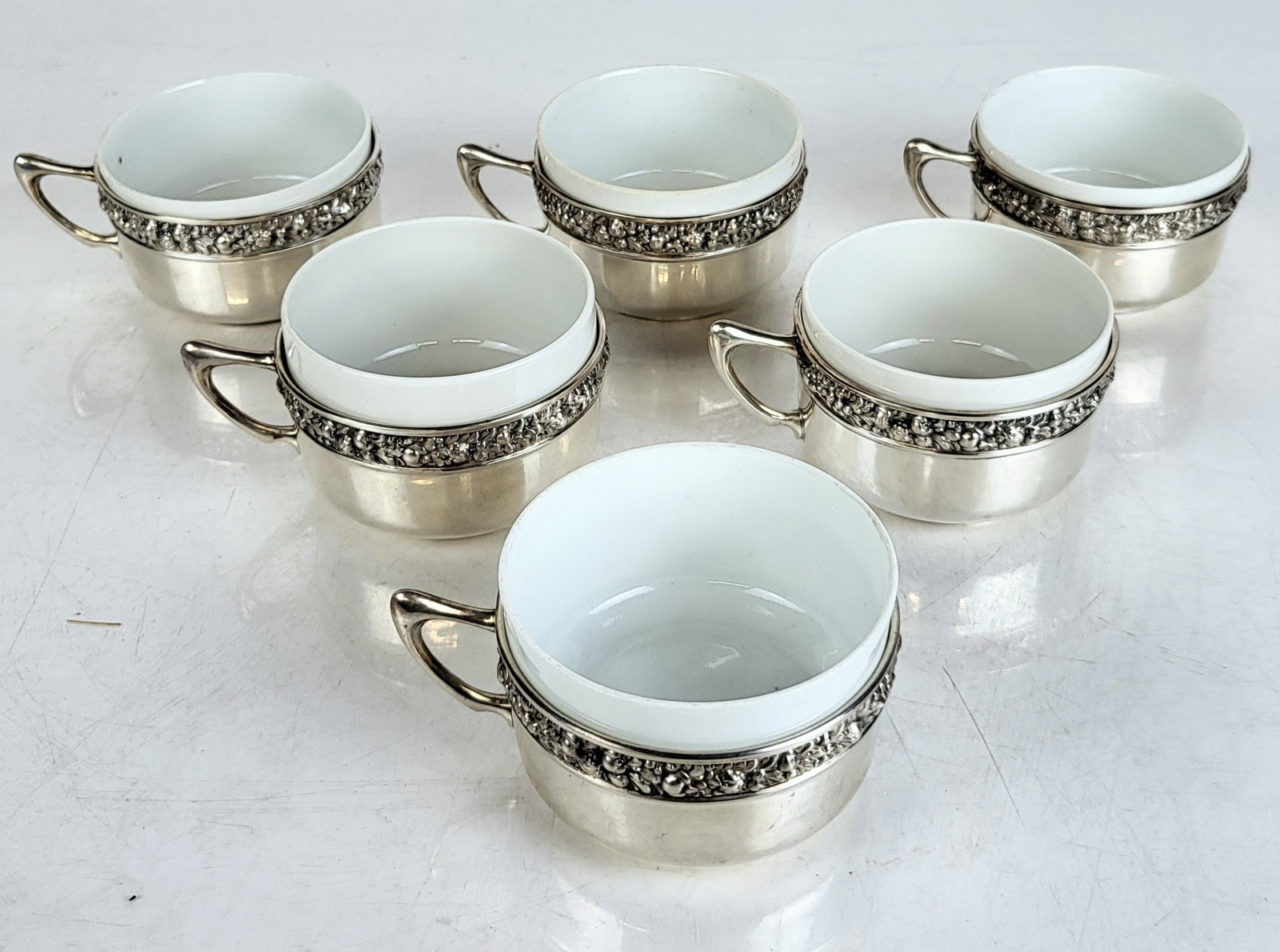 Six Silver and Porcelain Coffee Cups: Six 800. quality silver and porcelain coffee cups, liners total 10 ozt., marks to base. Overall condition is good. Property of an important NY philanthropic family.