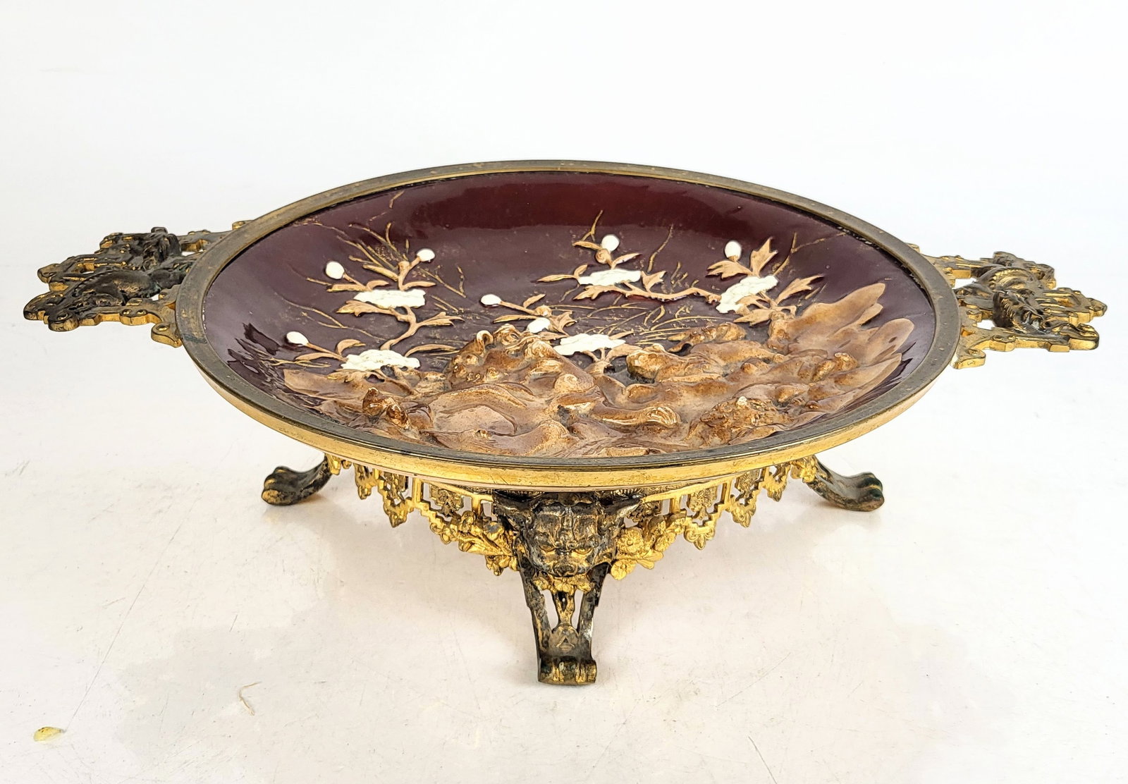 Bronze Mounted and Porcelain Centerpiece: Bronze mounted and porcelain centerpiece, probably French, 20th century, with pierced and dragon decorated handles, a bowl with foo dog and flower designs standing on four beast form paw feet with a '