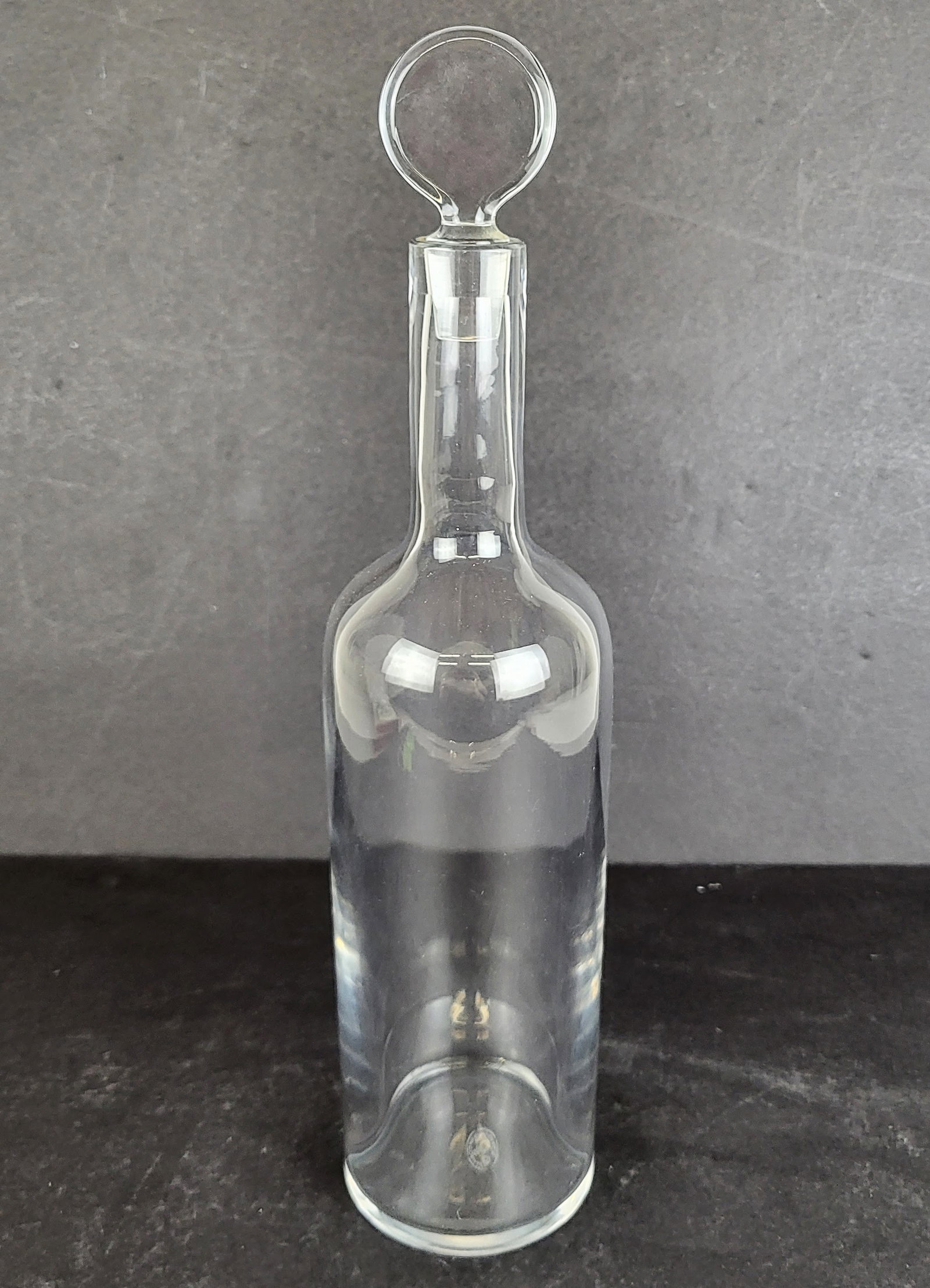 Baccarat Crystal Decanter: Baccarat crystal "Dyonsis" stoppered decanter, mark to base [14" H x 3" Diameter] Overall condition is good. From the Estate of Laura Leonard Ault