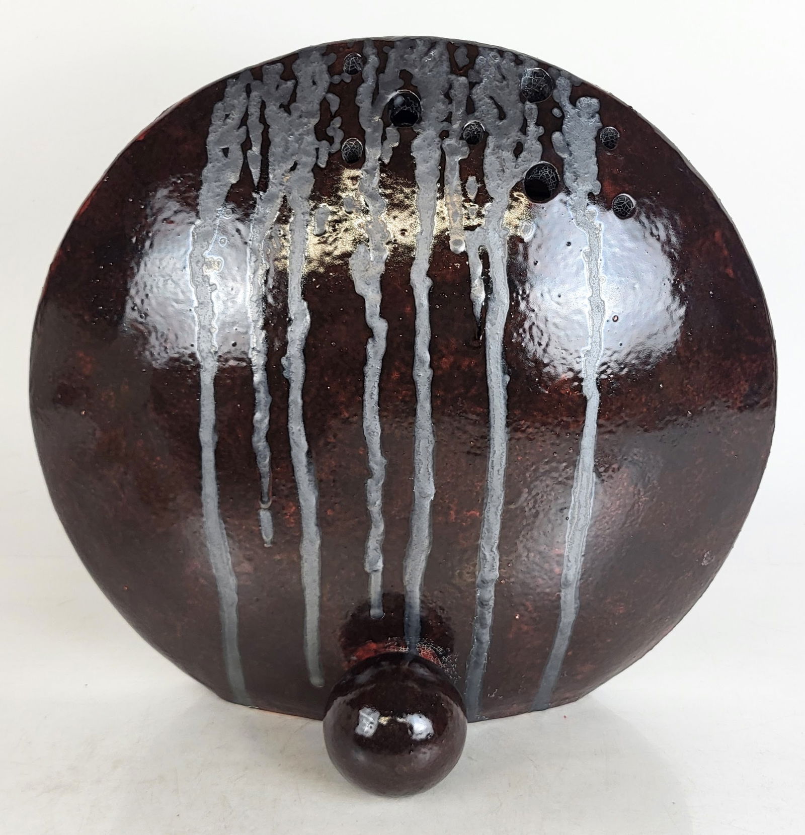 Renato BASSOLI Ceramic Sasso Vessel: Renato Bassoli (Italy, 1915-1982) ceramic sasso vertical vessel in shades of burnt orange, burgundy, brown, and cinnamon, textured and punctuated, signed on base. [14" H x 15" W x 5" D]. Overall condi