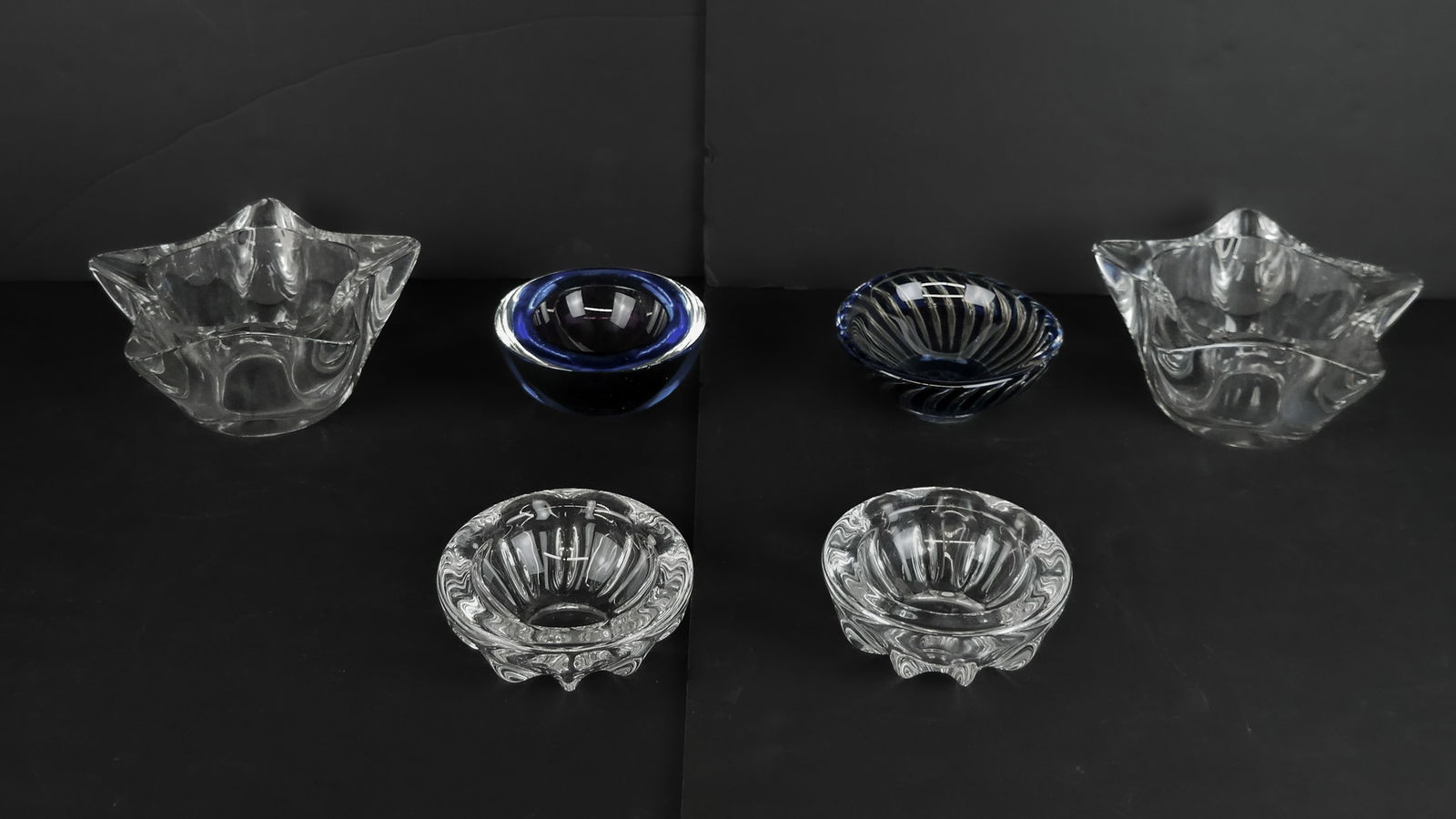 Orrefors & Others Glass Candy Dishes / Ashtrays, 6: Collection of colorless and blue/purple candy dishes / ashtrays comprising pair of colorless hemispherical dishes, pair of colorless star-shaped dishes, Edvin Ohrstrom for Orrefors blue and colorless
