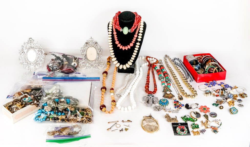 Group of Gold, Metal, Etc. Assorted Jewelry and Ar: Assorted group of costume jewelry comprising 2 silver-tone picture frames, 15 bracelets, 16 pair of earrings with odds and ends, 25 assorted brooches and pendants, 2 magnifying glasses on chains, 22 n