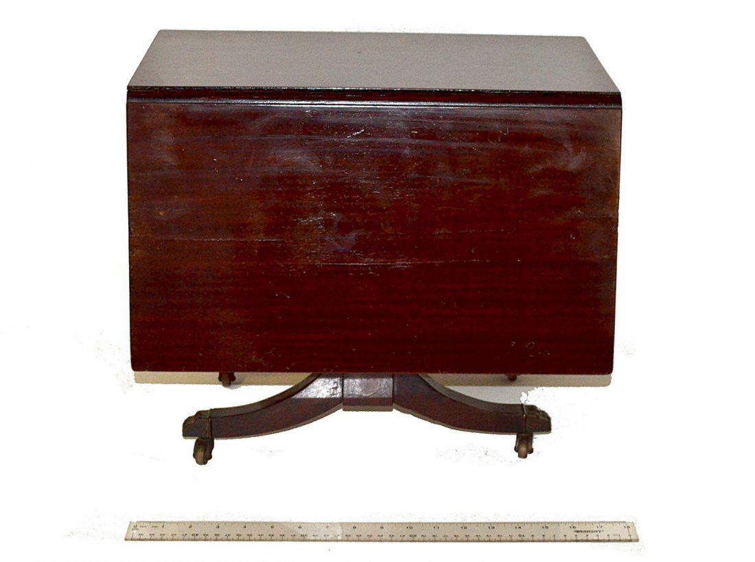 Miniature Drop Leaf Table: Duncan Phyfe style mahogany miniature drop leaf table. Scratches/worn. [18" x 30" x 15 1/2" H (open); Closed: 10 1/4"]