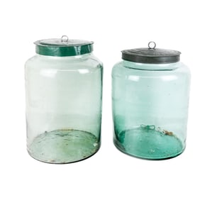 Two Antique Green Glass and Tin Storage Jars