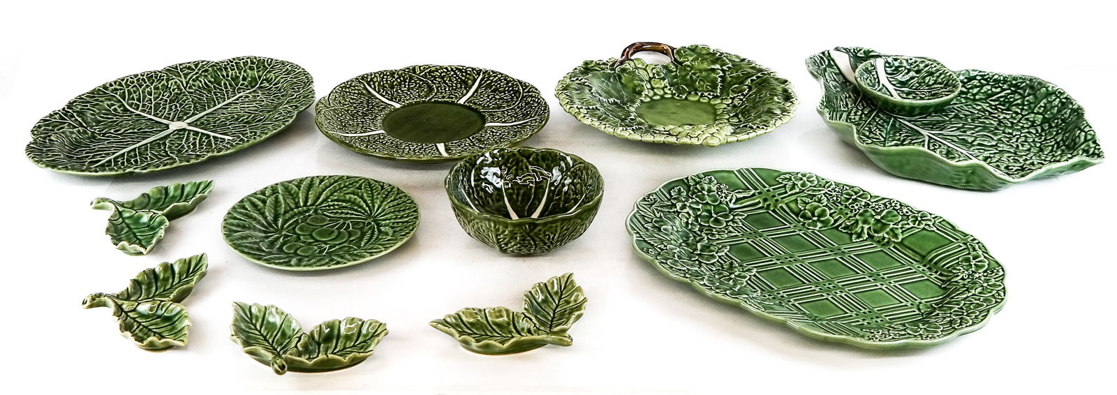 Group Bordallo Pinheiro and Other Serveware, 11: 11 pieces of Bordallo Pinheiro, Caldas, and other serveware comprising Bordallo Pinheiro cabbage oblong serving dish, four Bordallo Pinheiro Calda da Rainha double salts, a Bordallo Pinheiro green lat