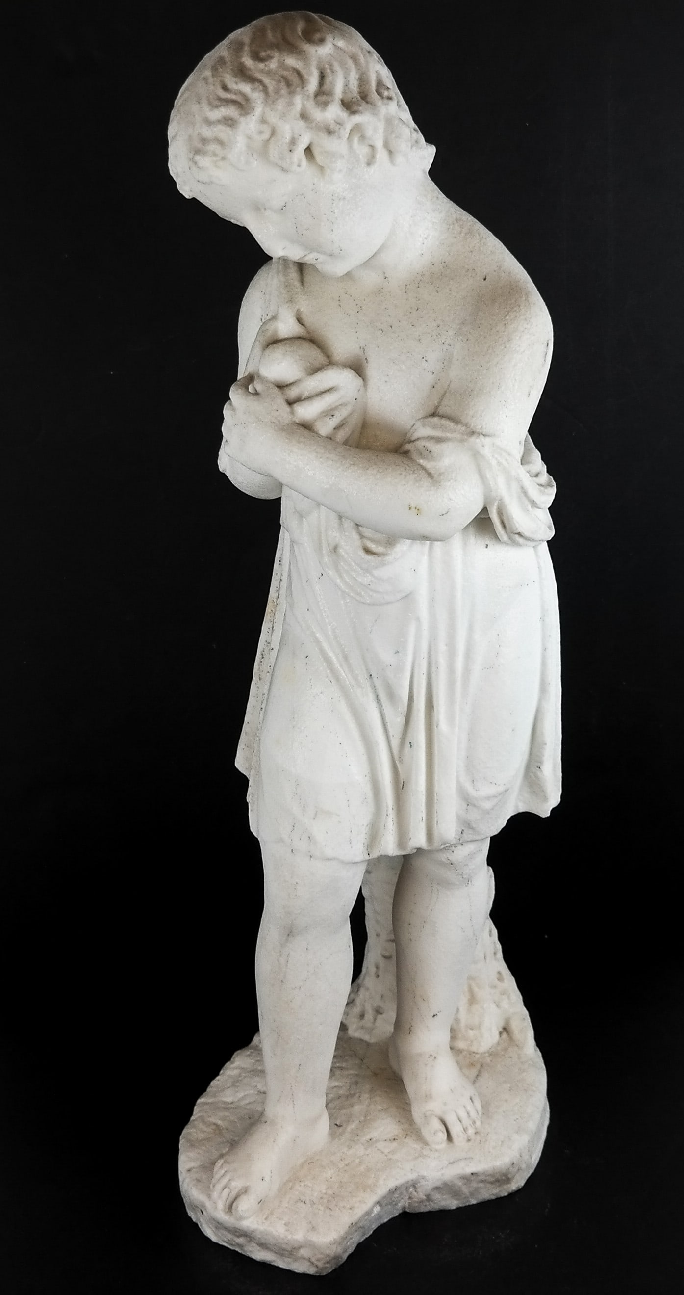 Italian Sculpture Of A Child: 20th century marble sculpture of a boy holding a bird, signed J. Cott. [29" H]. Pitting.