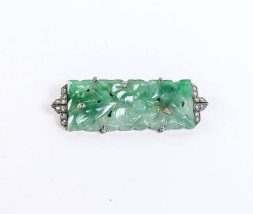Art Deco Jade and Diamond Brooch: Art deco carved jade and diamond brooch, silver topped white gold, 5.8 dwt. [1.75" Length]. Overall condition is good, some discoloration to metal.