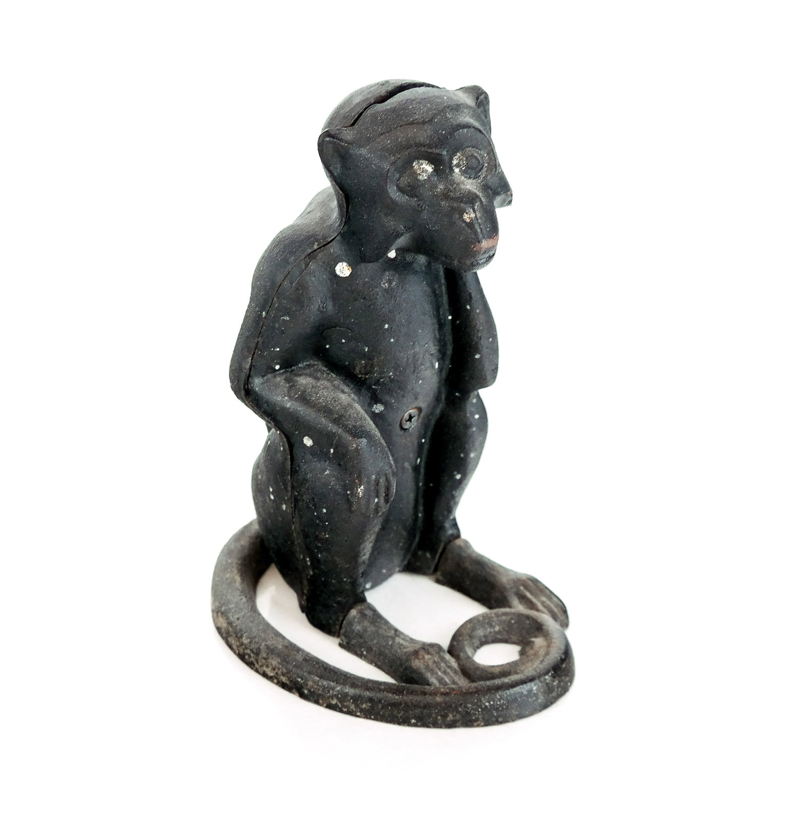 Cast Iron Monkey Form Coin Bank: Cast iron coin bank, American early 20th century, in the form of a seated monkey. [8.5" H x 4.75" W x 6.5" D]. Overall condition is good with loosening to screw at lower.